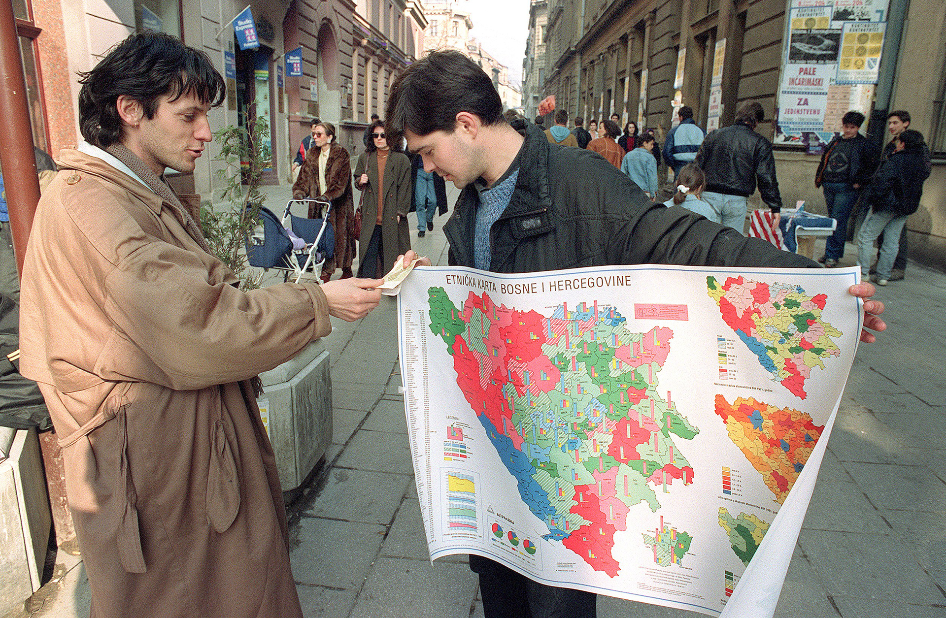 A street seller holds an ethnic distribution mag of Bosnia-Hercegovina as he talks to a fellow Bosnian in a Sarajevo shopping street 01 March 1992 while Bosnia-Hercegovina opened a second day of voting on independence. The state is the ethnic most varied in former Yugoslavia with Moslem Slavs, Croats and Serbs living together.