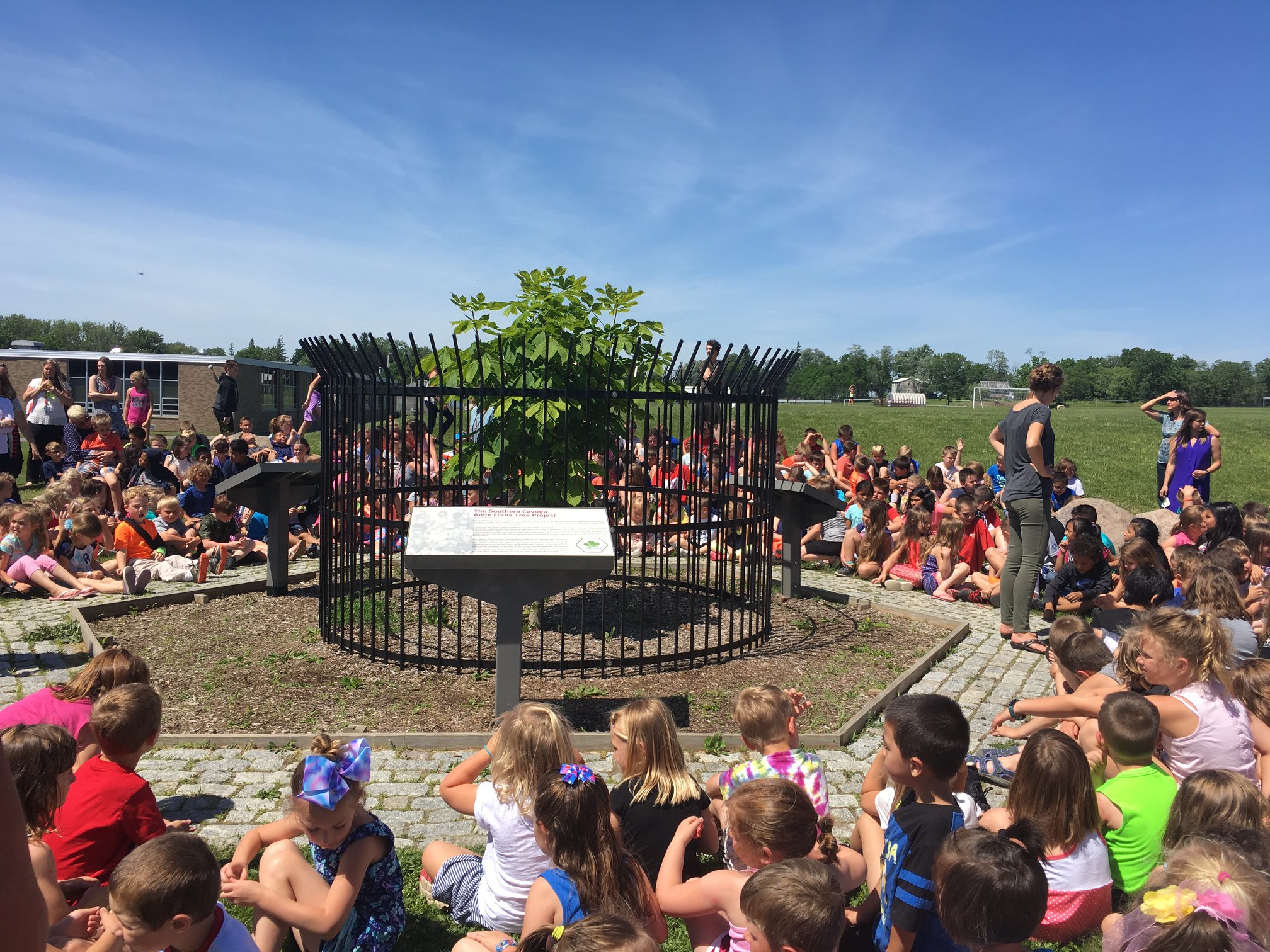 Children in Cayuga, New York, celebrate Anne Frank's 89th birthday in 2018 around Annie.