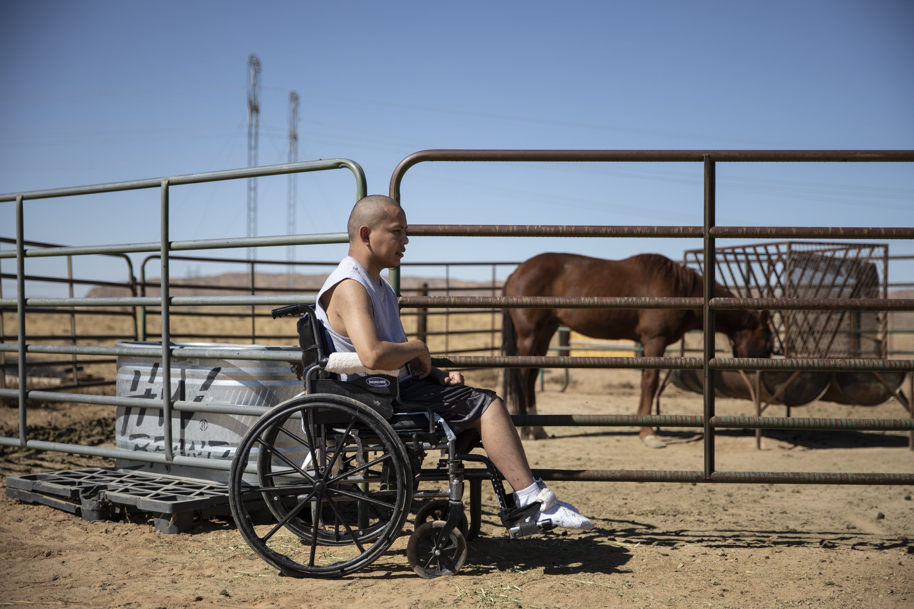Lydell Begay sits beside the horse corral at his home in Fruitland, NM on October 14, 2019.