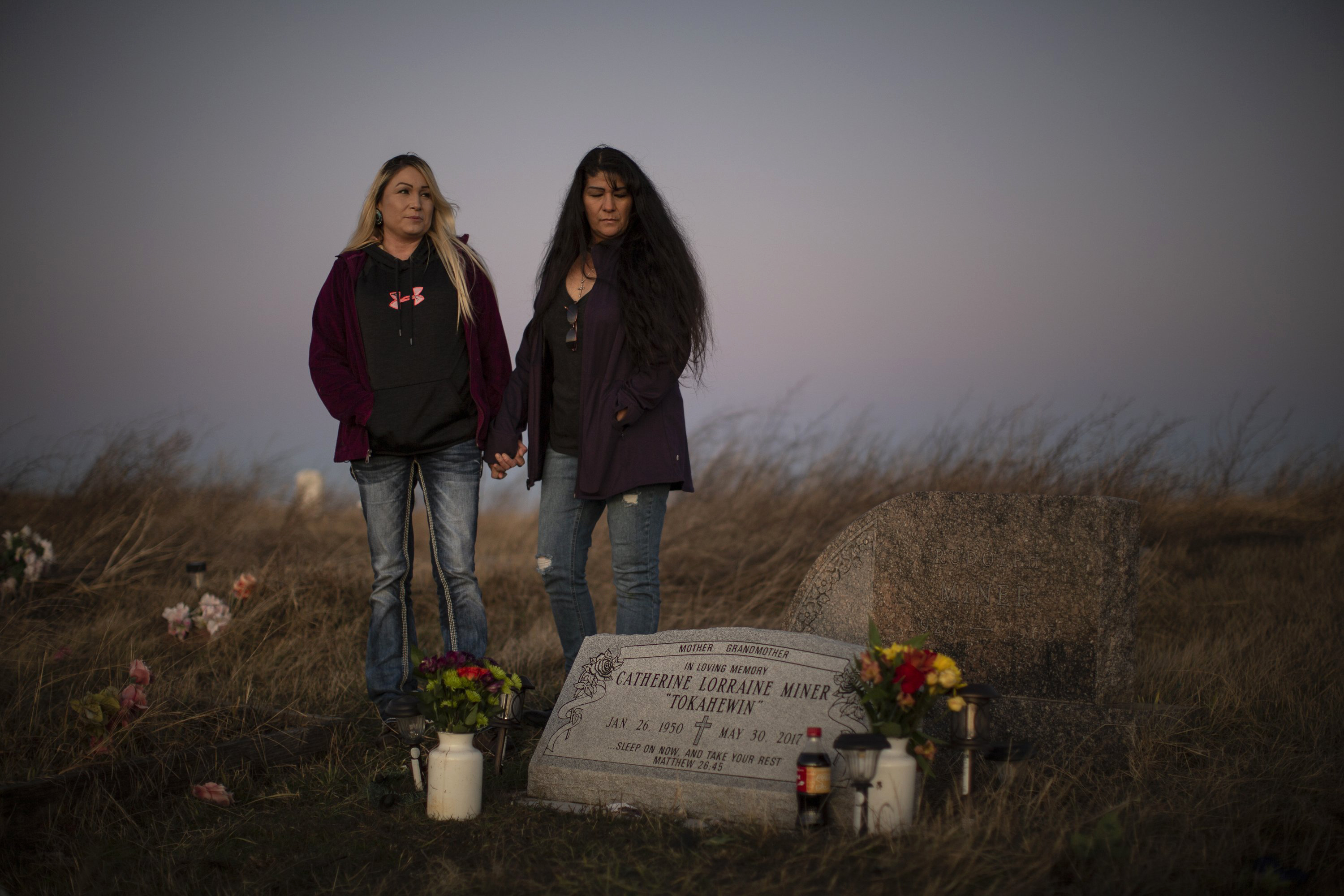 Lisa Tree Top, left, and her sister Kali visit their mother's grave in November.