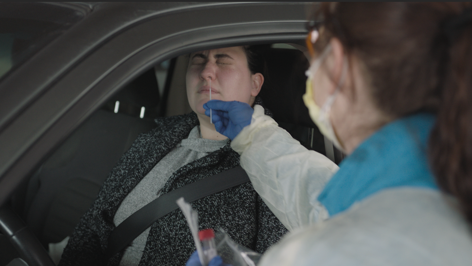 A hospital employee is tested at a drive-up testing site for COVID-19 at the hospital.