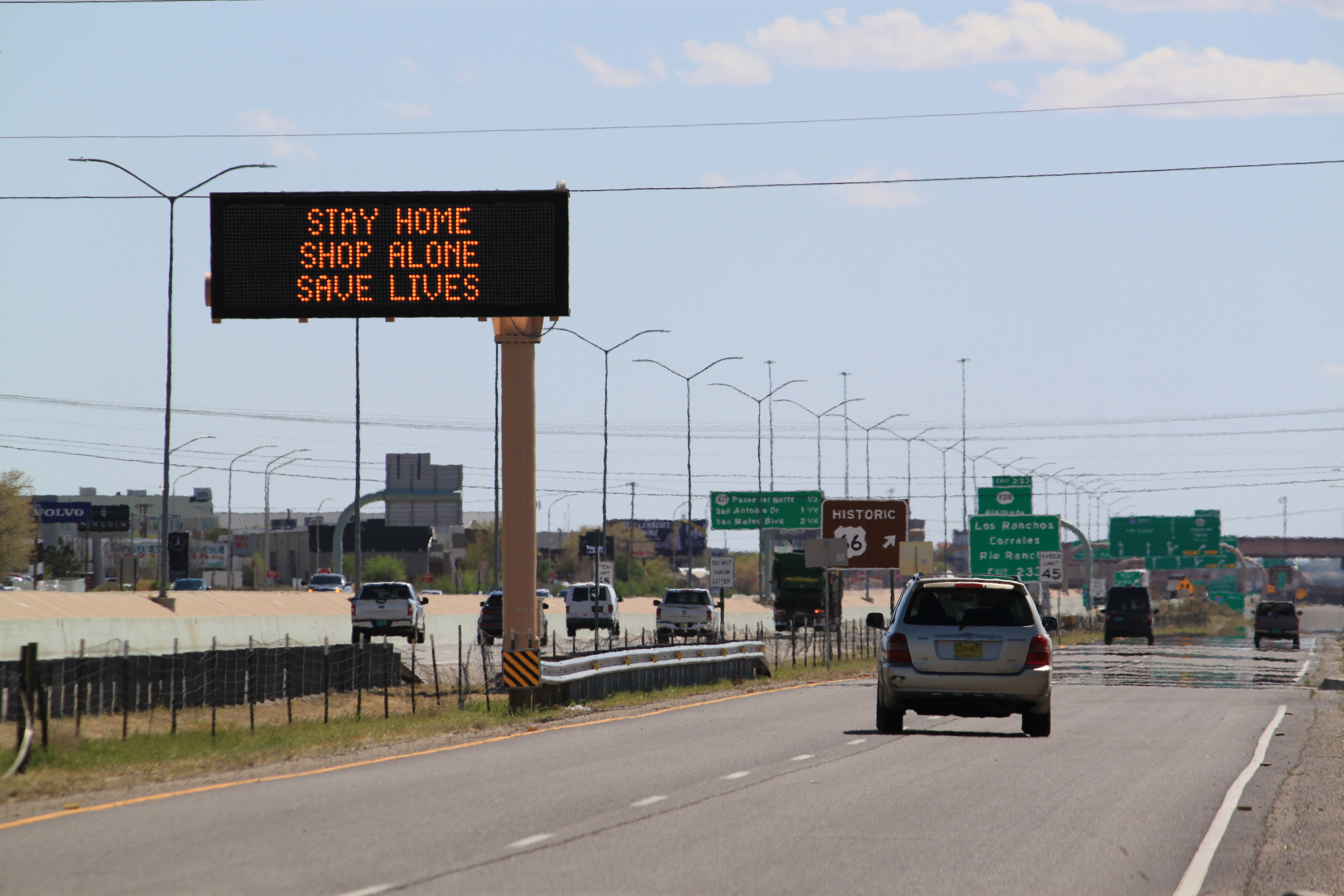 Flashing highway message boards along Interstate 25 in Albuquerque, New Mexico, urge people in both English and Spanish to stay home amid the coronavirus outbreak on Thursday, April 9, 2020.