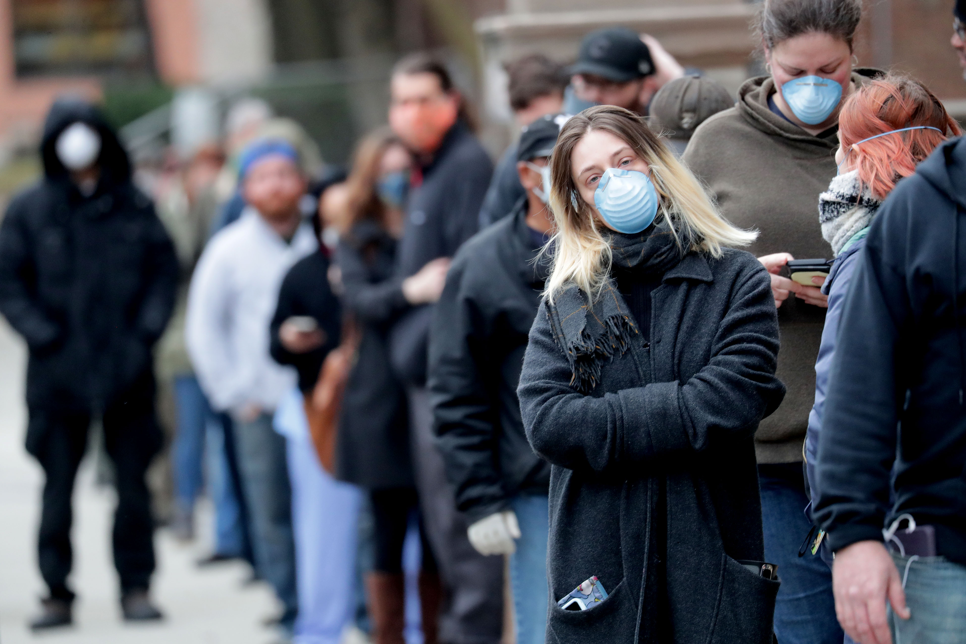 Hali Fisher, 24, waits in line to vote in Milwaukee on Tuesday, April 7, 2020. The Wisconsin primary went forward amid the coronavirus epidemic after Gov. Tony Evers' attempt to shut down the election was rejected by the Wisconsin Supreme Court on Monday.
