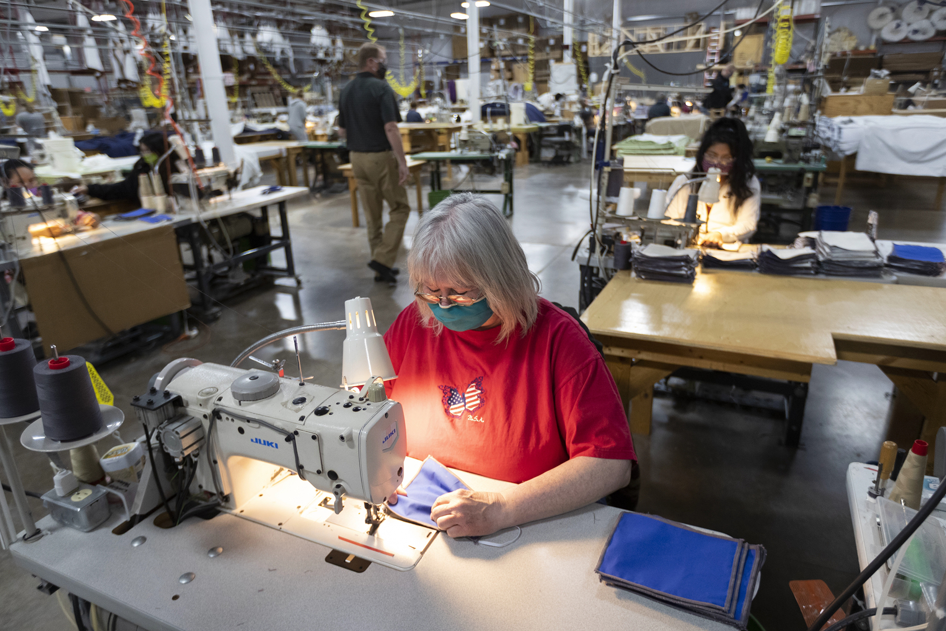 Workers sew non-medical masks on April 23, 2020 at Decorator Industries in Abbotsford, Wis. The company, which normally produces room furnishings for the hotel industry, quickly pivoted to making face masks.