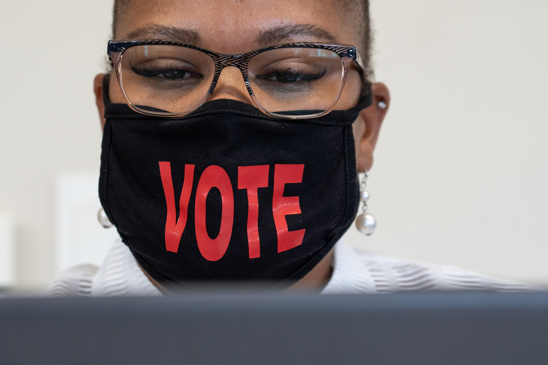 Voting processor Latoya Johnson-Fowlkes gathers voter information as part of the upcoming Michigan primary in Detroit on July 31, 2020.