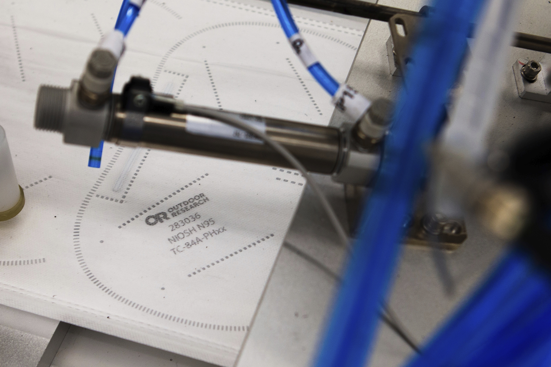 In this undated photo provided by Outdoor Research in September 2020, N95 filter material for face masks lies on a machine in Seattle. The company used its deep ties in the industry to secure meltblown material and, in the summer, the FDA sanctioned its N95 masks.