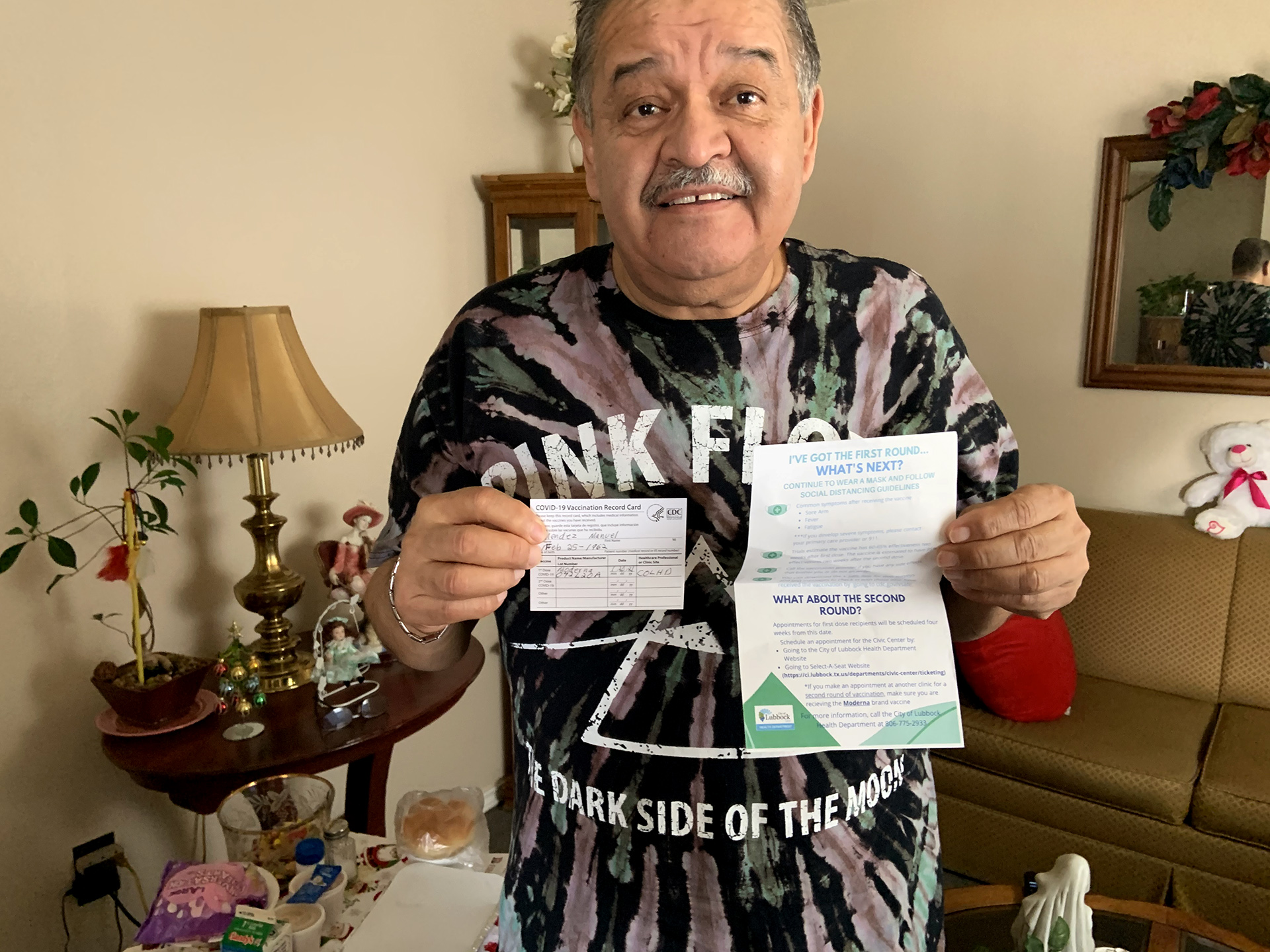 Levelland resident Manuel Mendez holds his inoculation record and a sheet of instructions following the first dose of the COVID-19 vaccine.