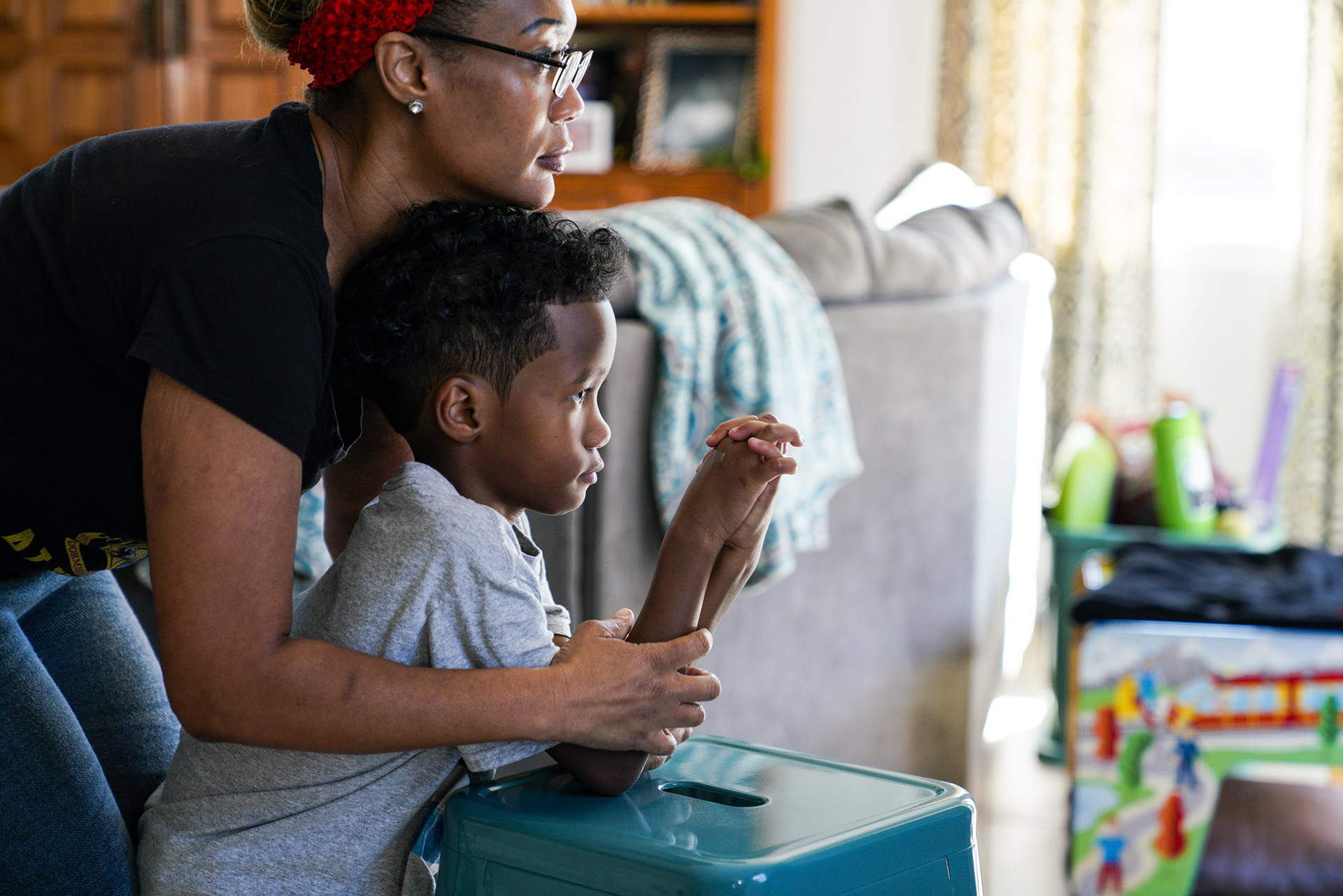 Tomika Bennett, 45, helps her son, Colin Brown, 7, with a wrist exercise during his occupational therapy session which is done virtually, at home every week. Colin was diagnosed with autism and had high lead levels in his blood at a young age, which his parents believe was due to his father, Ko Brown, bringing it home from his work at Gopher Resource. The occupational therapy includes low-impact exercises, memory games, and work to improve fine motor skills, including writing, on Tuesday, Feb. 2, 2021 in Zephyrhills .