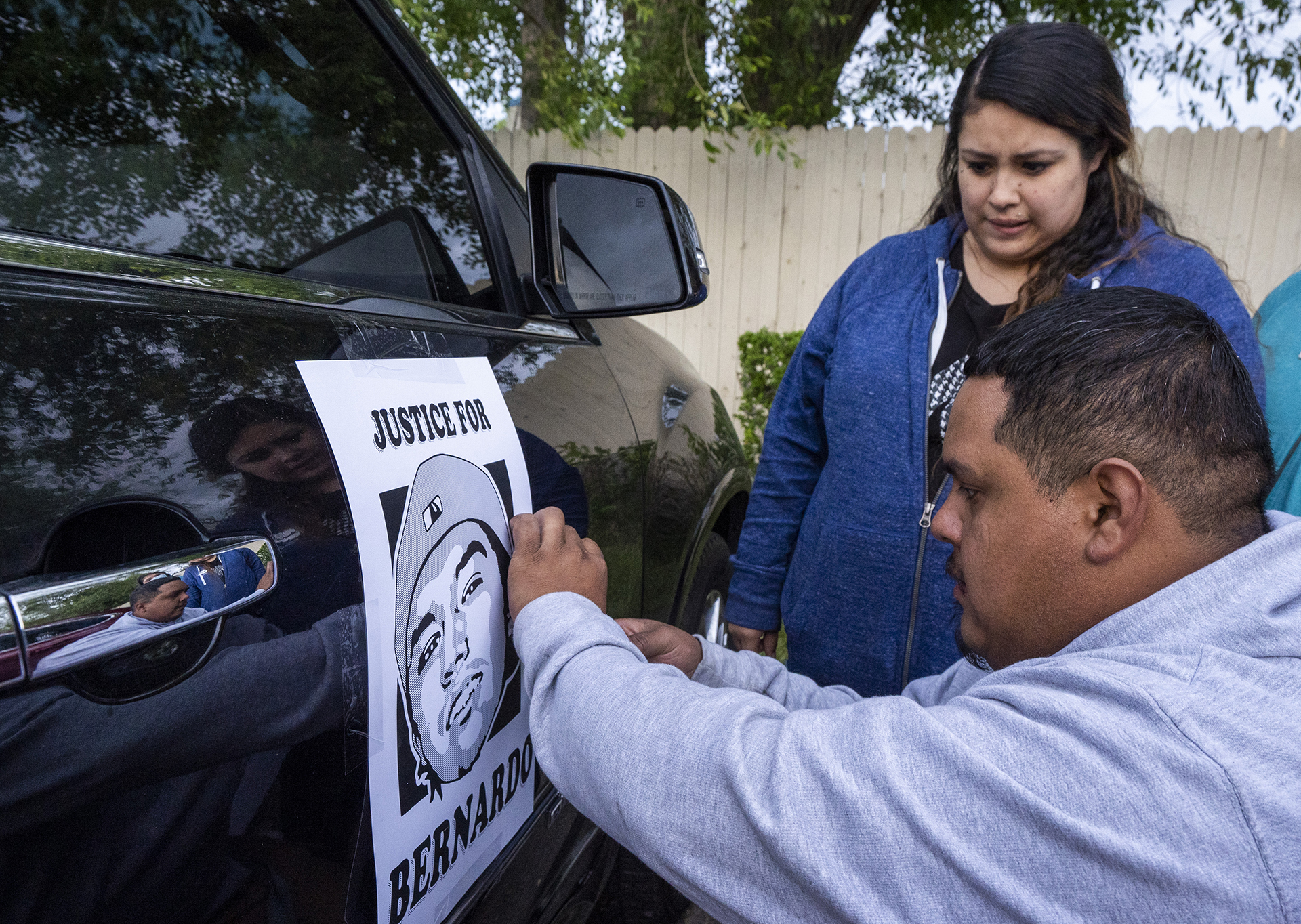 Carlos Torres and Griselda Romero tape a "Justice for Bernardo" sign on their car before driving to the Salt Lake City Cemetery, after the "Long Live Loske" gathering at Rose Park on Saturday, May 22, 2021. The family of Bernardo Palacios-Carbajal hosted a "1st Heavenly Anniversary" event to celebrate the life of their son and brother to mark the 1-year anniversary of his death on May 23, 2020 by Salt Lake City Police, who fired 34 shots, killing the 22-year-old man.