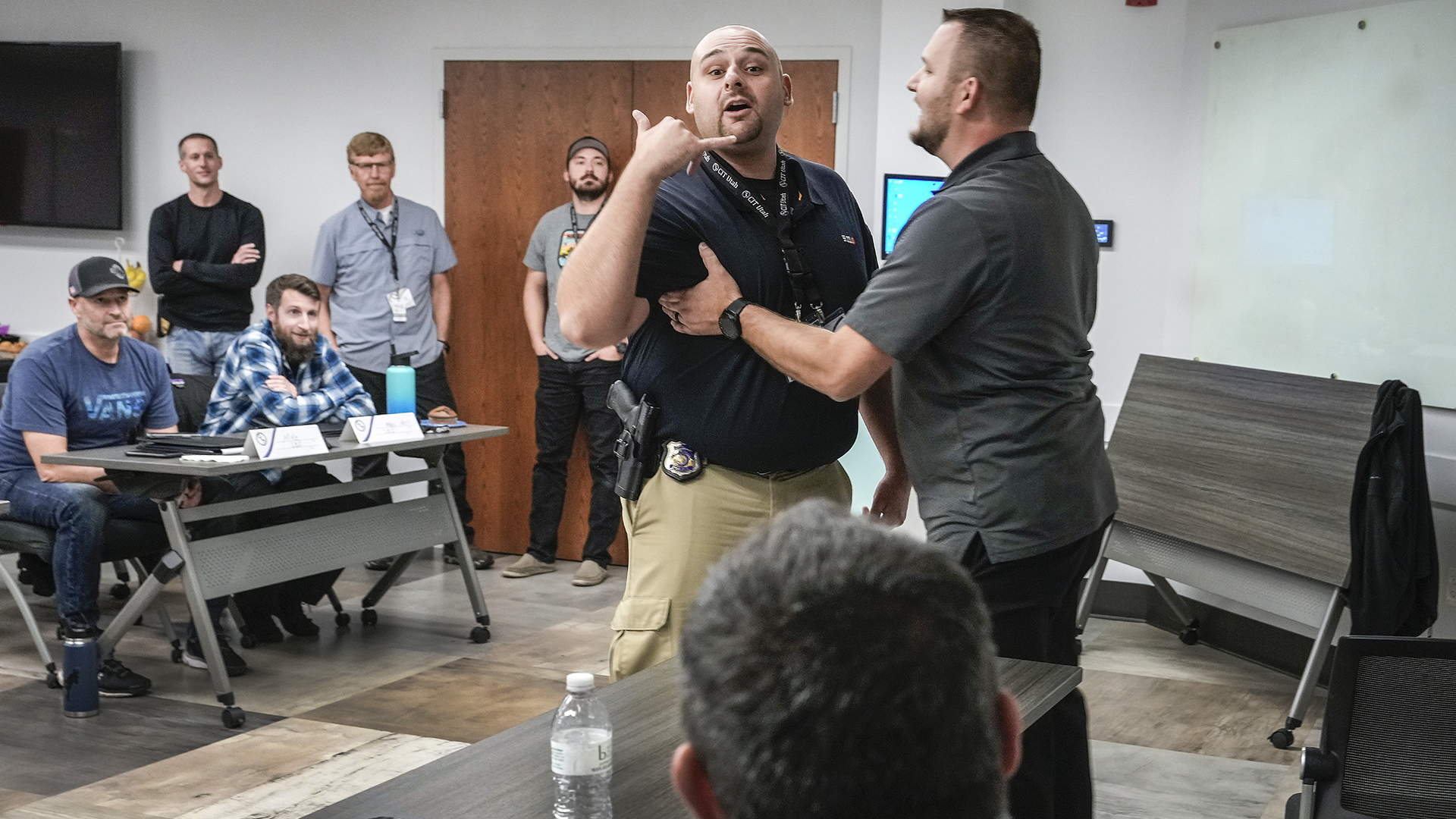 Brandon Mortensen with the Utah Highway Patrol holds back Logan Police Department officer Mike Montoya who role plays as a bus driver who is frustrated with passenger Dr. Todd Soutor, who plays the role of someone who is manic and won't leave the bus. Police officers from multiple agencies attend Crisis Intervention Team training or CIT at the Layton Police Department, Nov. 4, 2021.  The officers role play various scenarios to strategize new crisis intervention responses in dealing with the public.