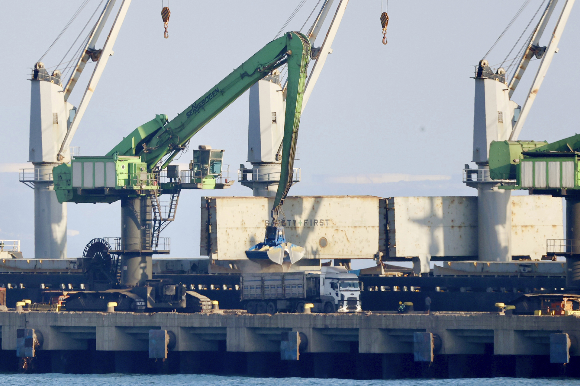Grain from the cargo ship Mikhail Nenashev is loaded onto trucks at a Russian-owned steel mill in Dörtyol, Turkey, on June 25, 2022. An Associated Press investigation shows the ship, owned by a sanctioned Russian state-owned defense contractor, is part of an extensive Russian-run smuggling operation that has been hauling stolen Ukrainian grain from ports in occupied Crimea to customers in the Middle East. (AP Photo/Yoruk Isik)