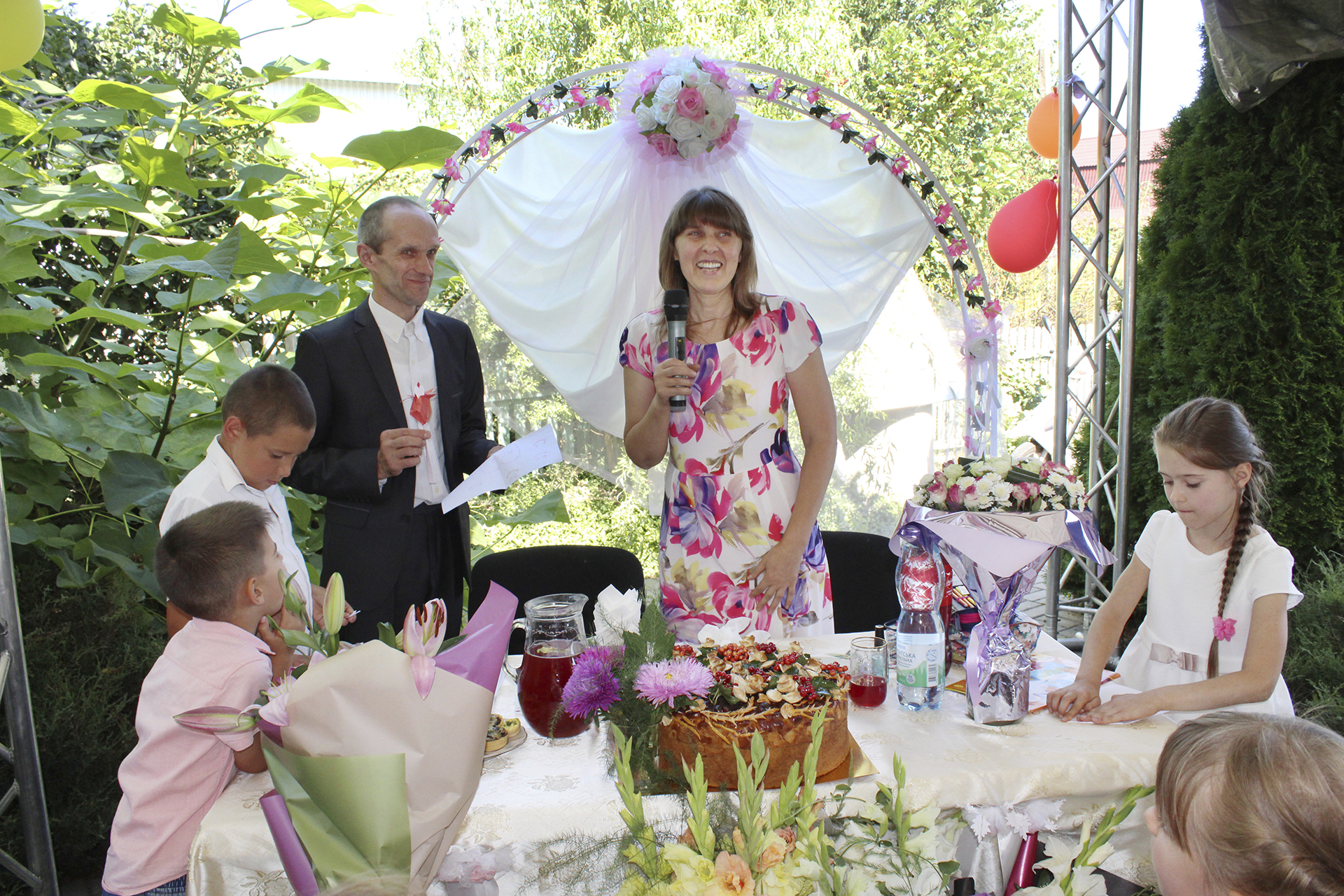 In this photo provided by Tetiana Boikiv, she, center, and Mykola "Kolia" Moroz celebrate their wedding in Ozera, Ukraine on Aug. 16, 2020. They’d met at the botanical garden in Kyiv on a church outing for singles. Boikiv had moved to Ozera – a village of 2,000 before the war -- just four months before Russia’s invasion to build a new life with Kolya. (Courtesy Tetiana Boikiv via AP)
