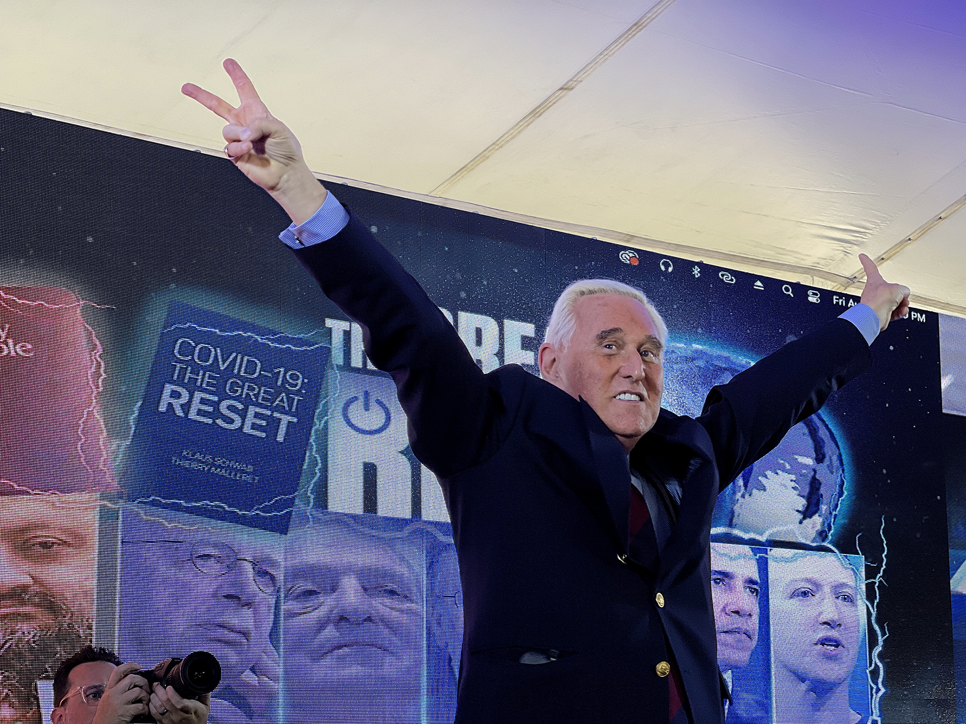 Conservative political consultant Roger Stone gestures victory to the cheering crowd during the ReAwaken America tour at Cornerstone Church, in Batavia, N.Y., Friday, Aug. 12, 2022. (AP Photo/Carolyn Kaster)