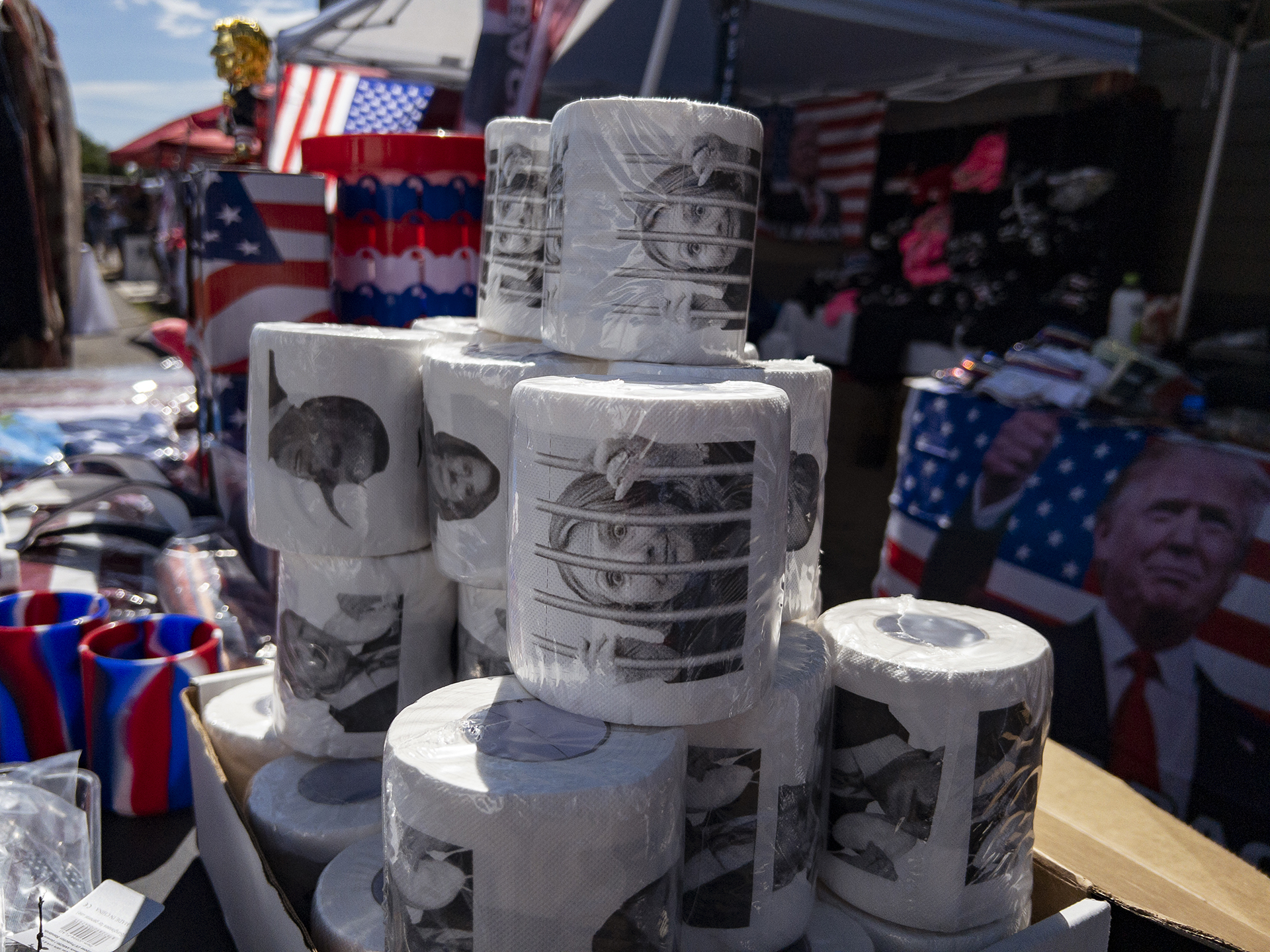 Merchandise, including toilet paper with the image of former Secretary of State Hillary Clinton, is displayed during the ReAwaken America tour at Cornerstone Church in Batavia, N.Y., Saturday, Aug. 13, 2022. (AP Photo/Carolyn Kaster)