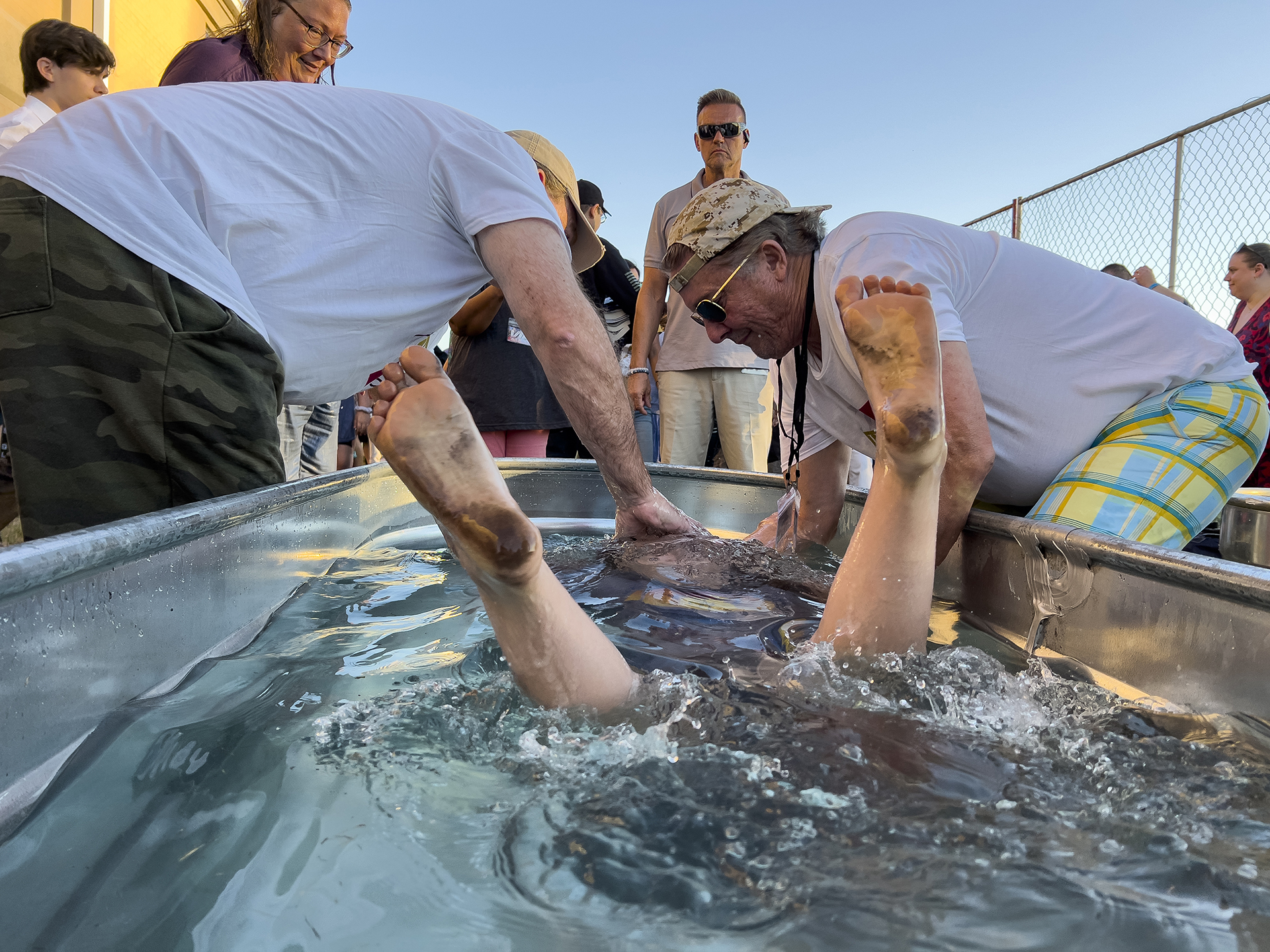 Bare feet of a girl shoot from the water as she is baptized during the ReAwaken America tour at Cornerstone Church in Batavia, N.Y., Friday, Aug. 12, 2022. (AP Photo/Carolyn Kaster)