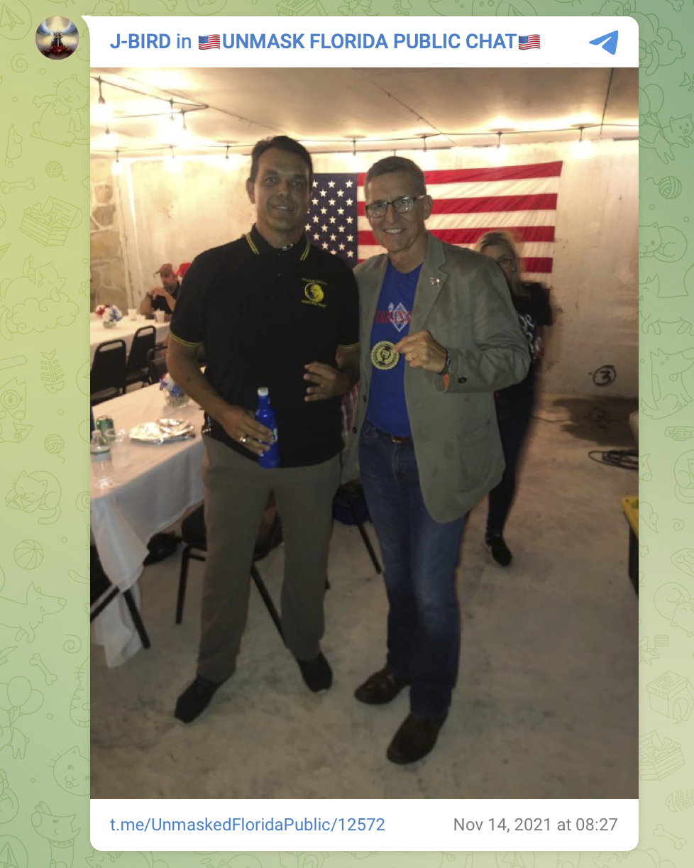 This photo posted on Telegram on Nov. 14, 2021 shows James Hoel, left, with Michael Flynn holding a Proud Boys insignia at The Hollow in Venice, Fla. The Proud Boys are a violent extremist group that has been designated a terrorist organization by the governments of Canada and New Zealand and labeled a hate group by the Southern Poverty Law Center, a nonprofit legal advocacy group.