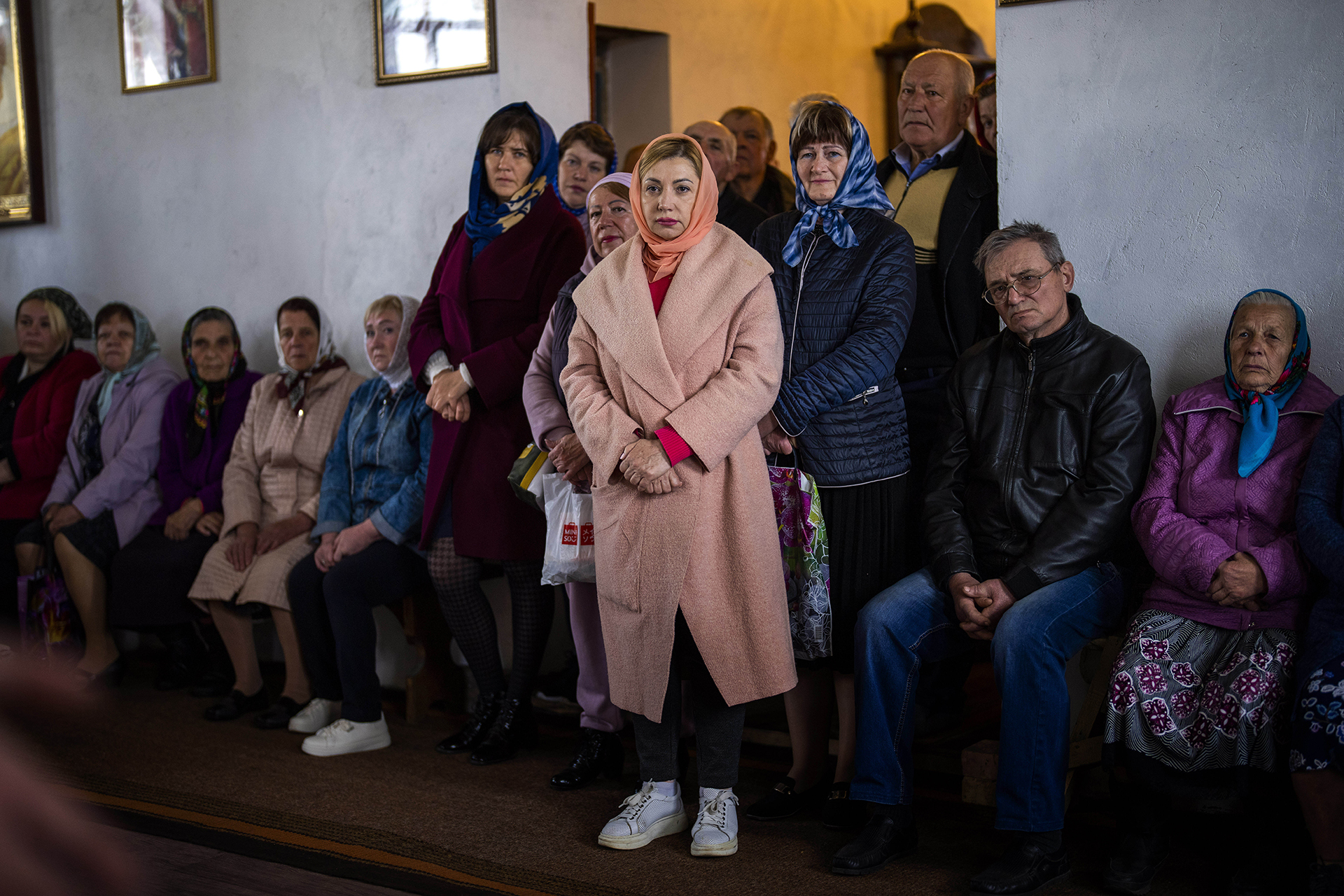 People attend a religious service to commemorate the fallen during the Russian occupation in Zdvyzhivka, Ukraine, on the outskirts of Kyiv, on Saturday, April 30, 2022. (AP Photo/Emilio Morenatti)