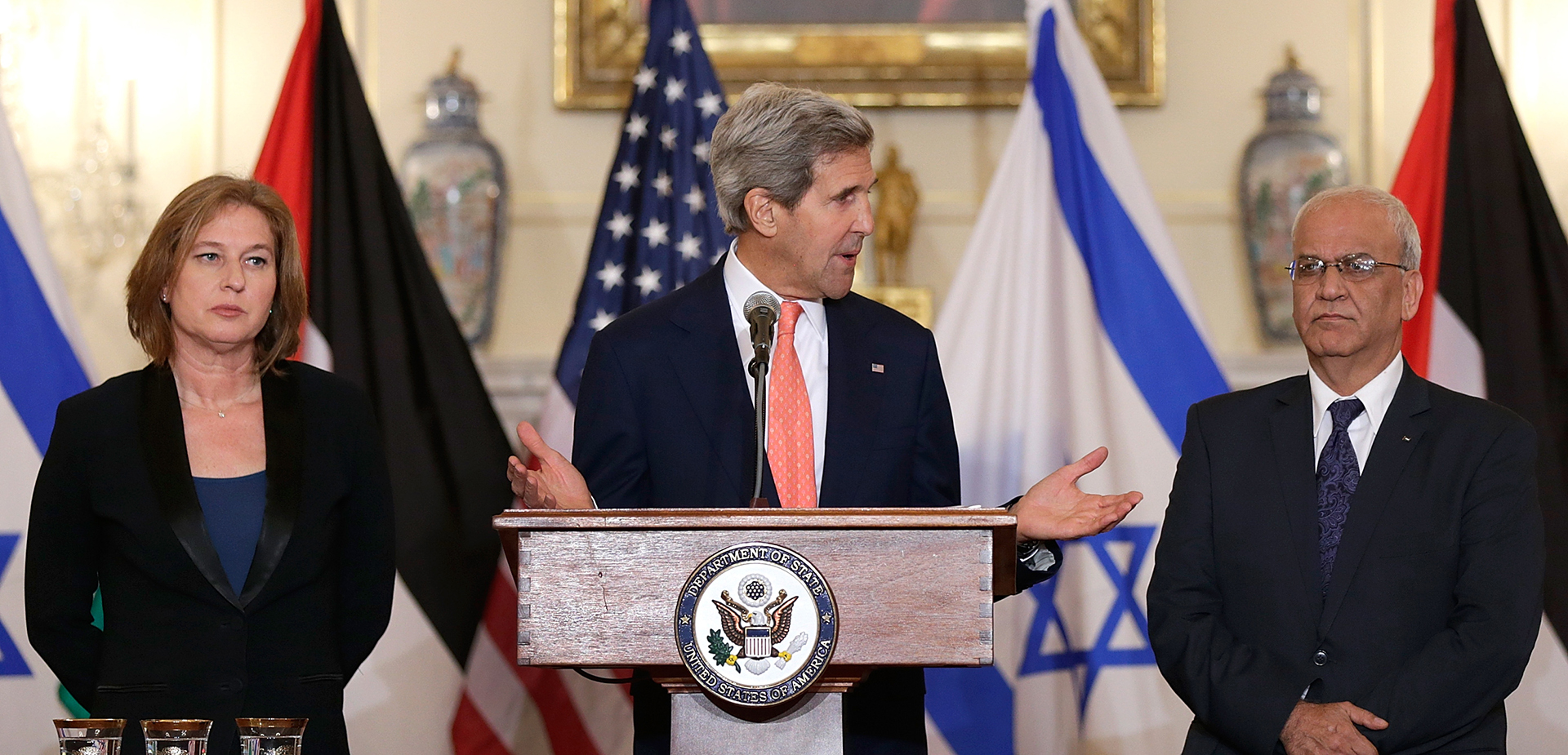 U.S. Secretary of State John Kerry with Israeli Justice Minister Tzipi Livni (L) and Palestinian chief negotiator Saeb Erekat (R) during a press conference on the Middle East peace process talks on July 30, 2013 in Washington, D.C.