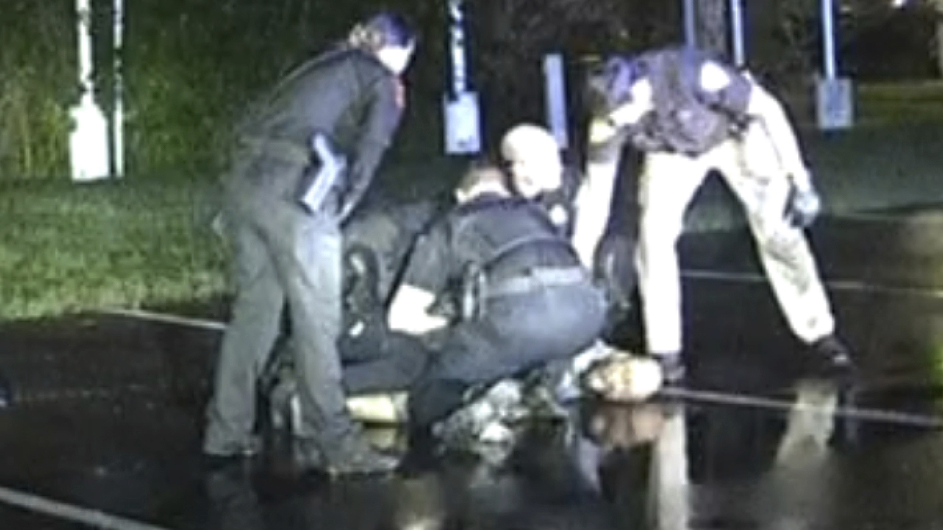 In this image from Eau Claire Police Department video, police restrain Demetrio Jackson in a parking lot in Altoona, Wis., on Oct. 8, 2021. The Associated Press documented more than 1,000 deaths over a decade after people were subdued through physical restraints, Tasers and batons, chokeholds, body blows and other “less-lethal force.”