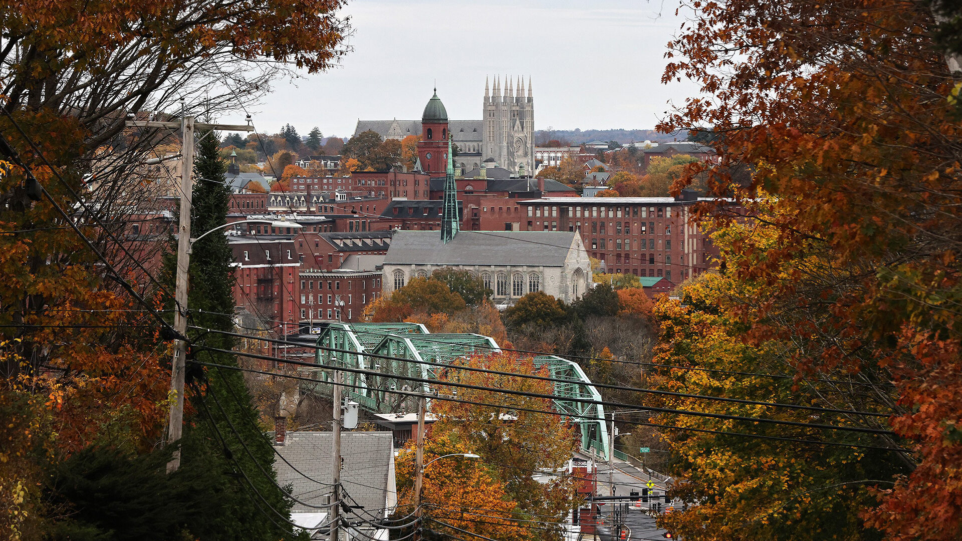 The city of Lewiston is framed by fall foliage as viewed from the top of Broad Street in New Auburn in October 2023.