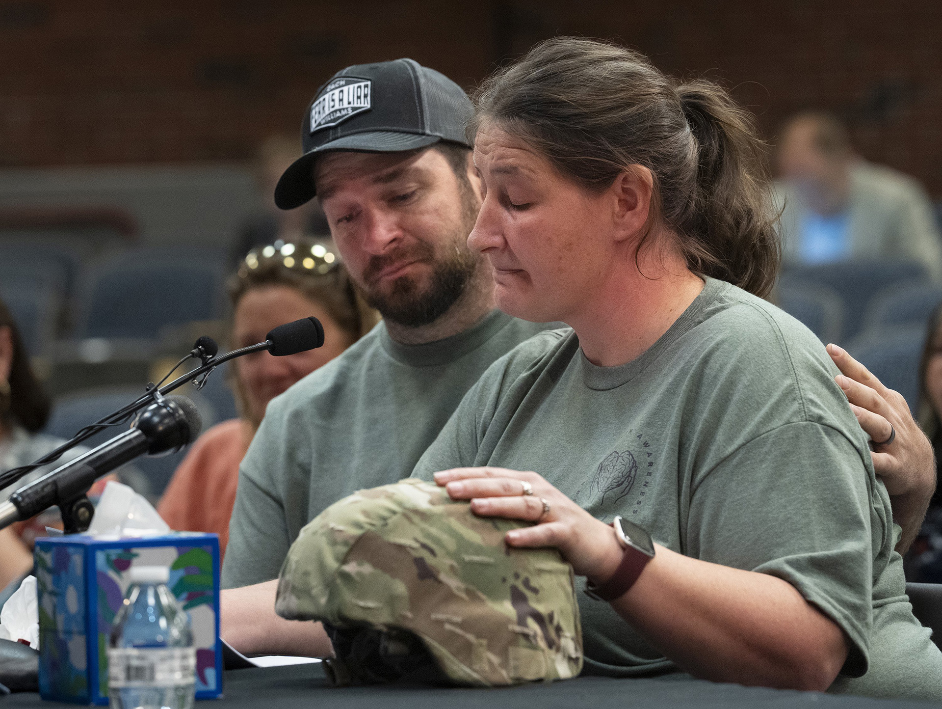Nicole Herling, Robert Card’s sister, sits with her husband James Herling as she rests her hand on her brother’s Army helmet while testifying in front of the commission investigating the Lewiston mass shooting. Gregory Rec/Portland Press Herald