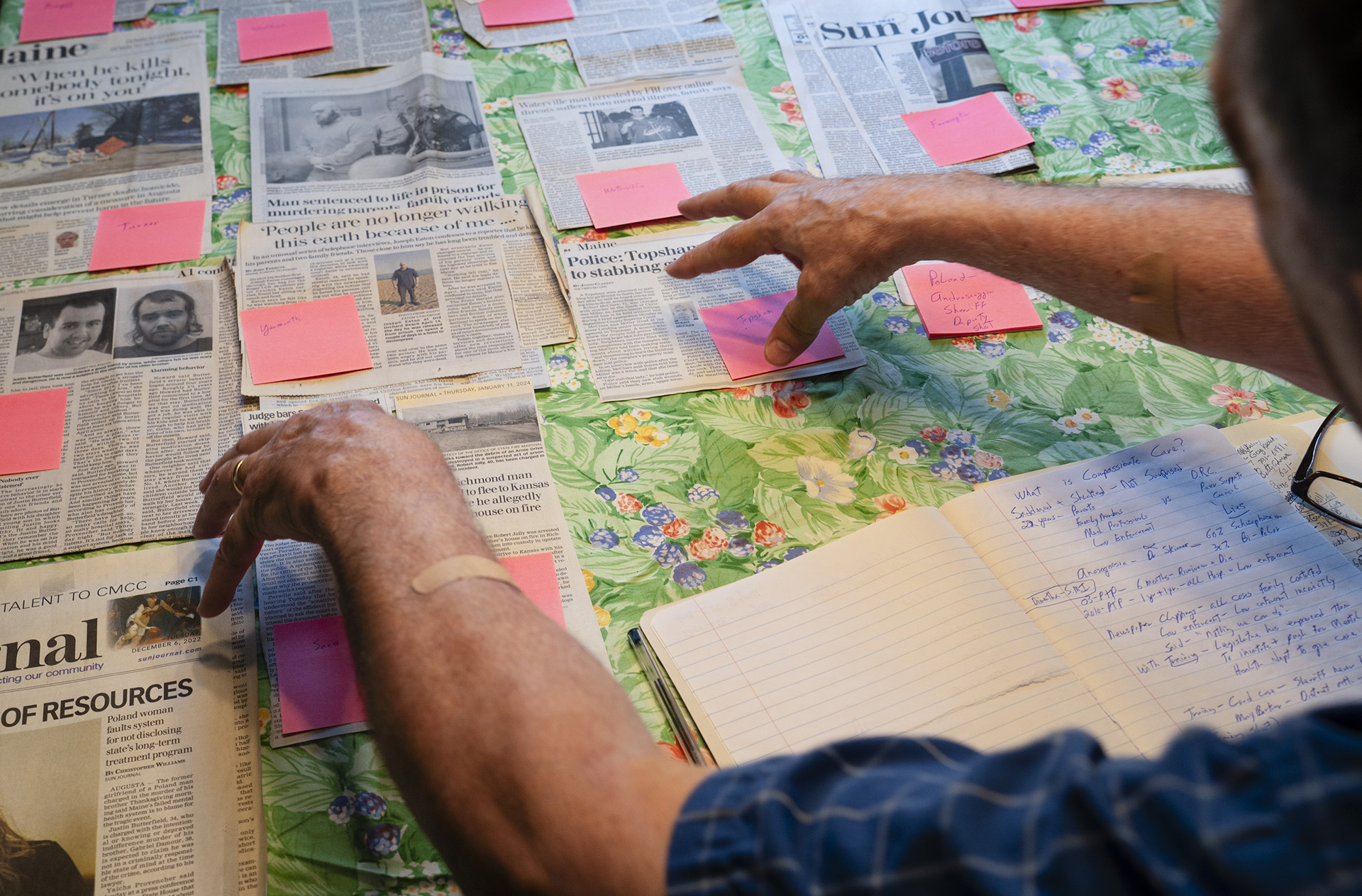 John Nutting points to a collection of news stories whose subjects he said could have benefitted from Maine's progressive treatment program. Carl D. Walsh/ Portland Press Herald