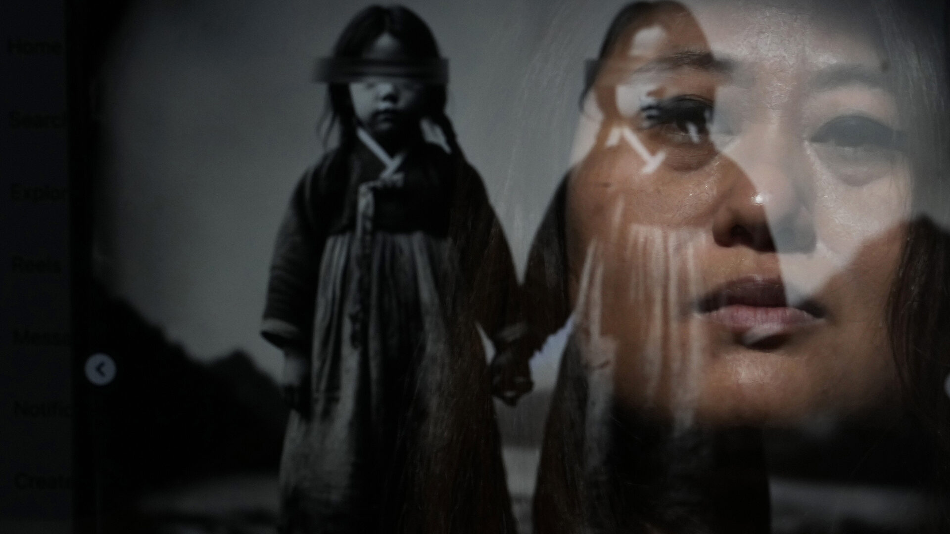 Rebecca Kimmel is seen reflected in her artwork depicting twins at her home Saturday, Feb. 3, 2024, in Seattle. Kimmel believes her adoption agency switched her identity with another girl, and that she may have a twin. Thousands of South Korean adoptees are looking to satisfy a raw, compelling urge that much of the world takes for granted: the search for identity. (AP Photo/Lindsey Wasson)