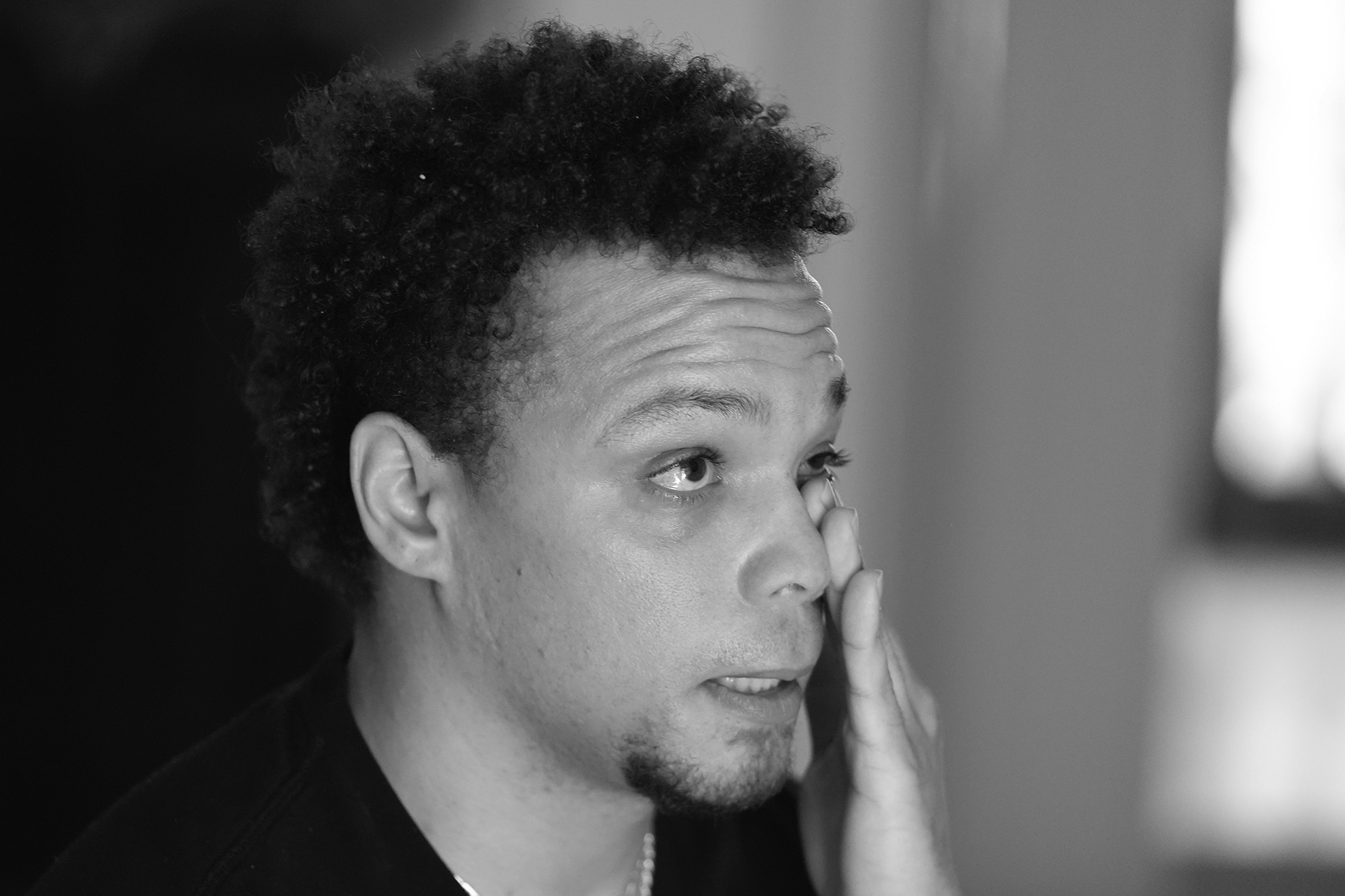 Lij Hacker wipes away a tear while talking about his late brother, Asson Hacker, during an interview in Bloomington, Ind., on June 4, 2024. (AP Photo/Darron Cummings)
