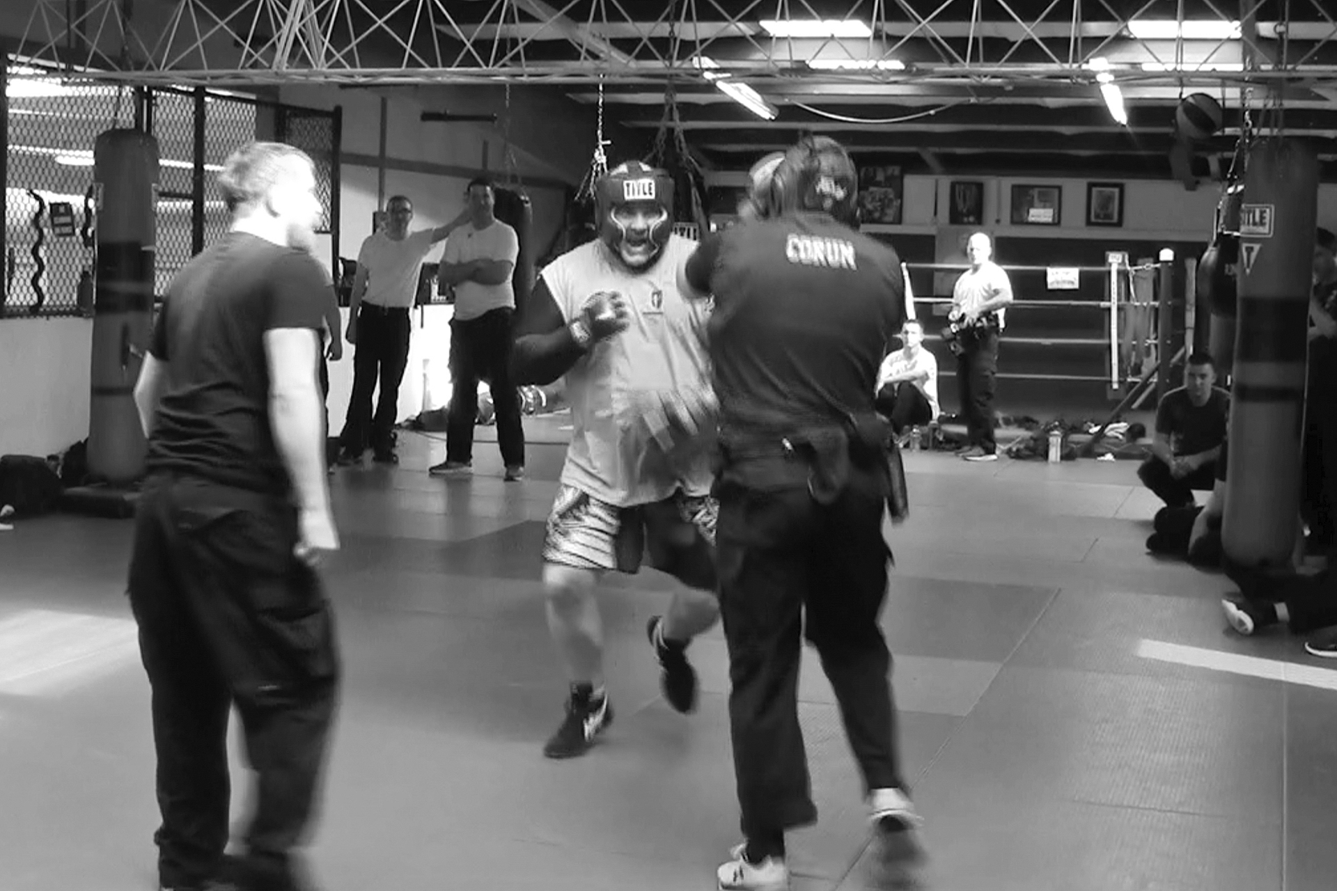 In this image from video made by the Evansville Police Department, police recruit Tanner Corum, foreground right, undergoes training with Mike Fisher, a sheriff's major from a nearby county, during "Big Fight " day for the Southwest Indiana Law Enforcement Academy in Evansville, Ind., on March 2, 2023. (Evansville Police Department via AP)