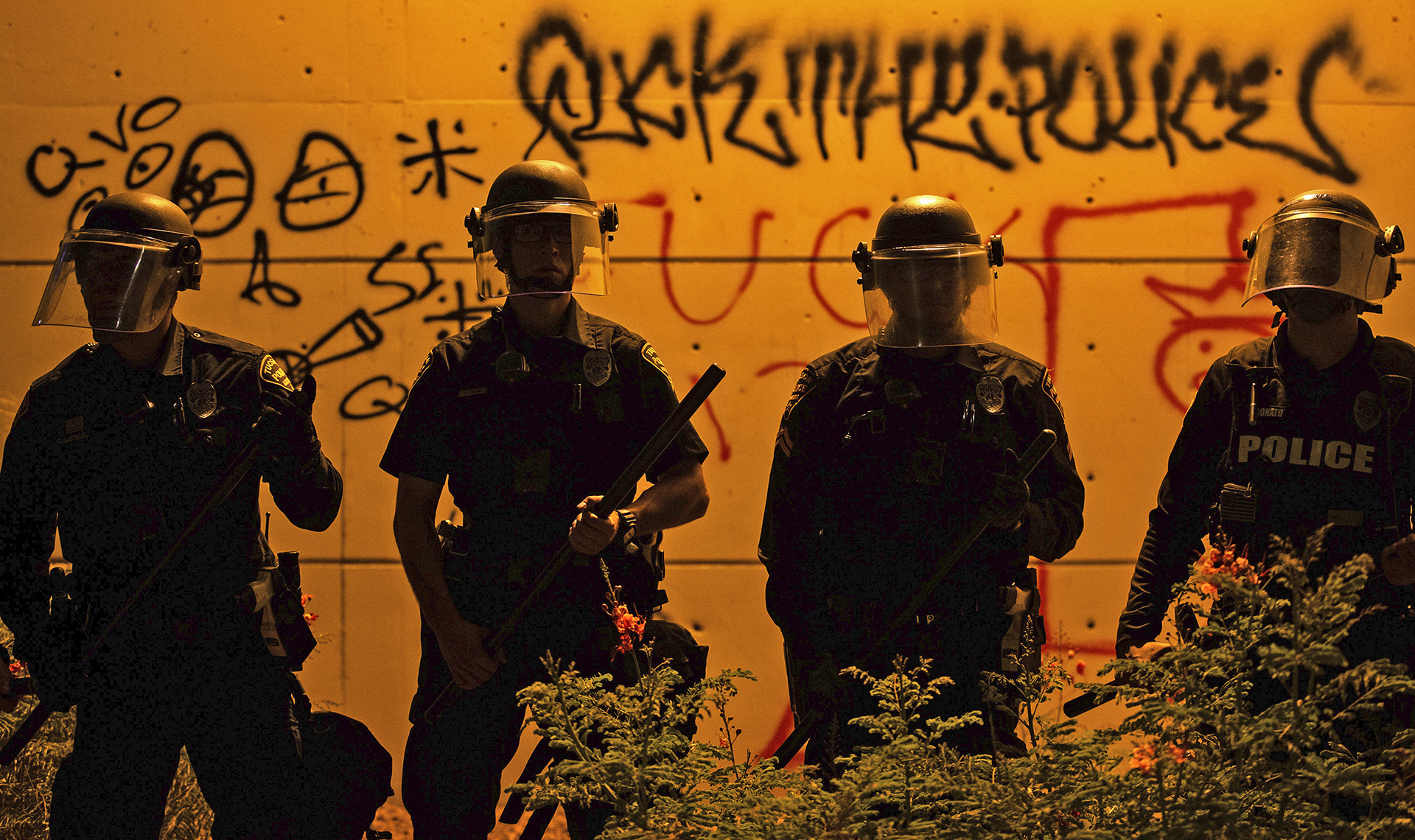 FILE - Police officers in riot gear stand at Cushing Street and Church Avenue while facing a group of several hundred protesters in Tucson, Ariz., on May 29, 2020, during nationwide protests in the wake of George Floyd's death. (Josh Galemore/Arizona Daily Star via AP, File)