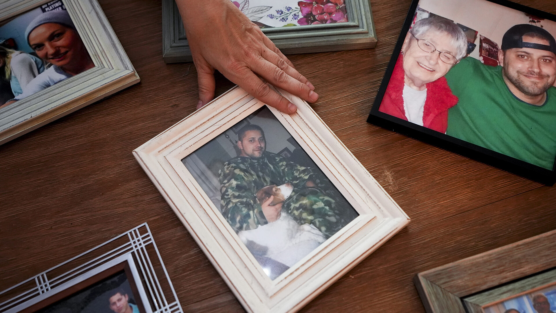 Jen Dold, whose brother, Alex Dold, lived with schizophrenia and died after a 2017 encounter with sheriff's deputies and police officers, displays family photos of her brother Wednesday, Sept. 18, 2024, at her home in Edmonds, Wash.