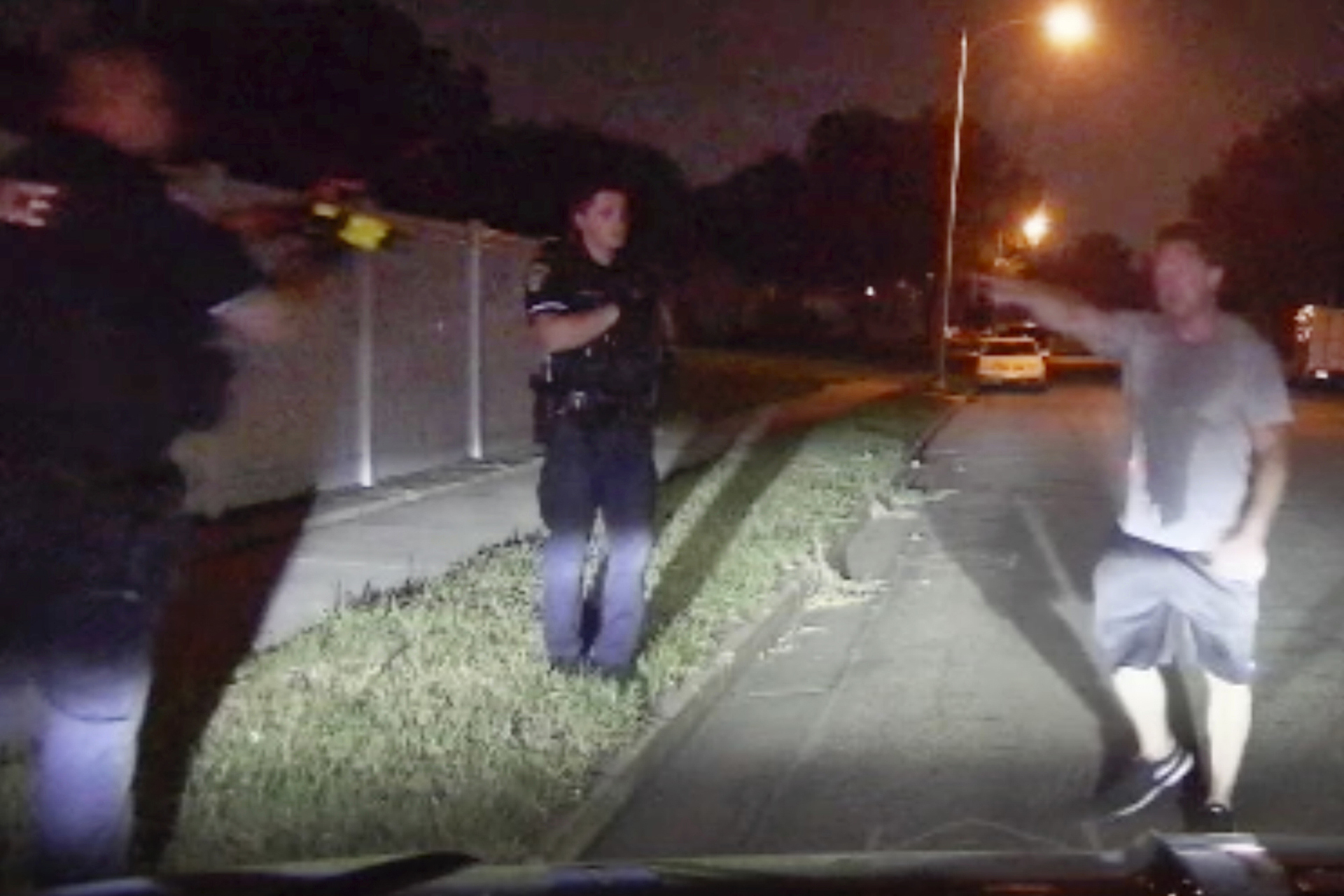 In this image from video provided by the Bismarck Police Department, officers, one pointing a Taser, confront Ryan Pederson in Bismarck, N.D., on Aug. 7, 2021. (Bismarck Police Department via AP)
