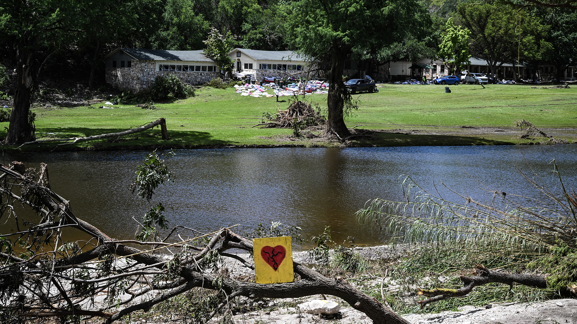 A painted broken heart is seen near Camp Mystic along the Guadalupe River in Hunt, Texas, on July 8, 2025, after severe flash flooding over the July 4 holiday weekend.