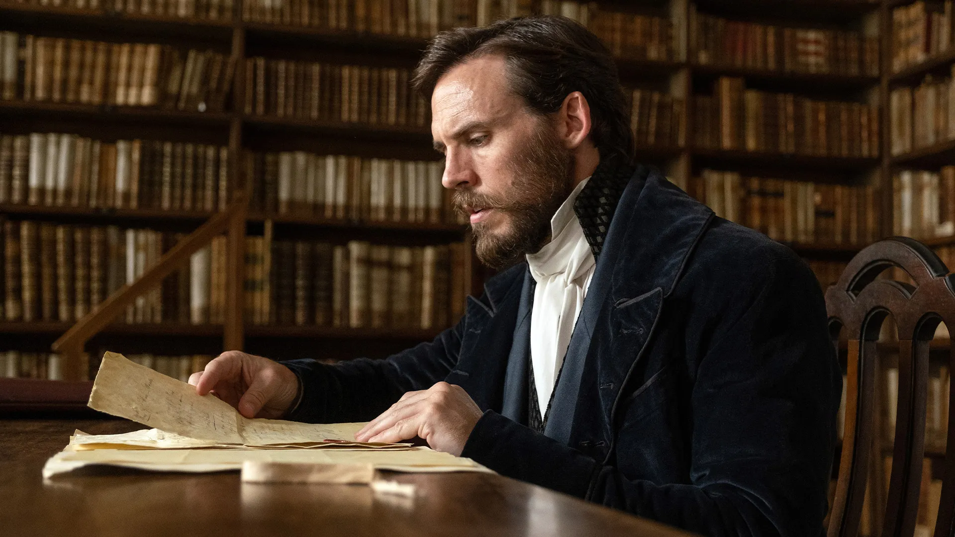 Actor Sam Claflin as The Counte of Monte Cristo reading in his library. The show is seen on MASTERPIECE on PBS.