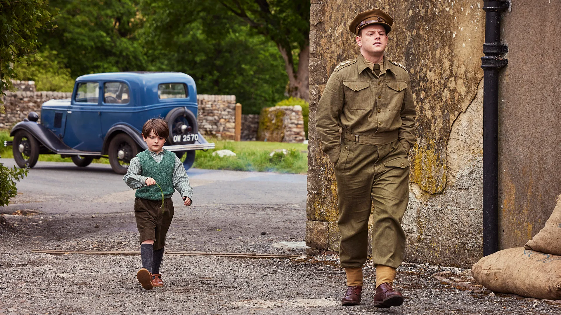 Characters Jimmy Herriot and Tristan Farnon in a street scene from All Creatures Great and Small Season 6 on MASTERPIECE on PBS.