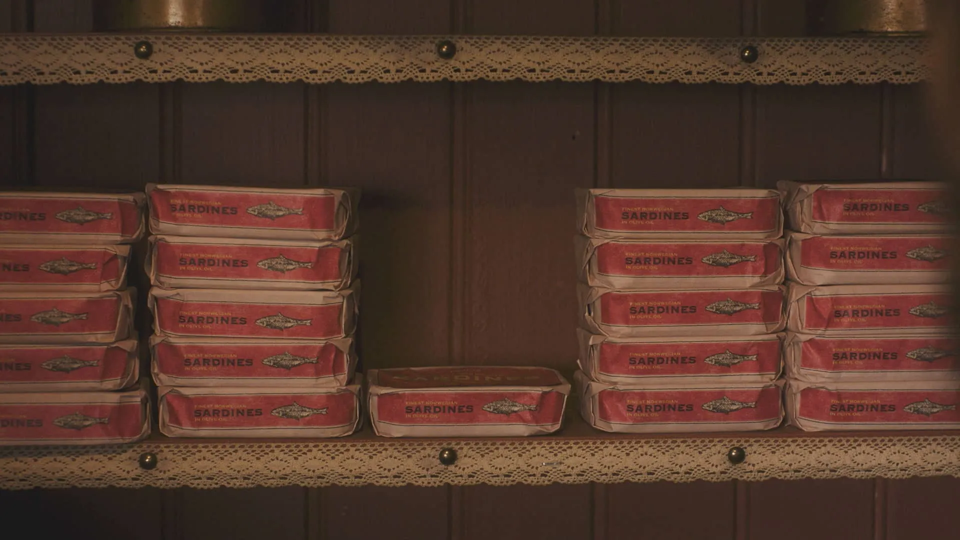 A closeup of stacks of sardine tins in the pantry of Skeldale House