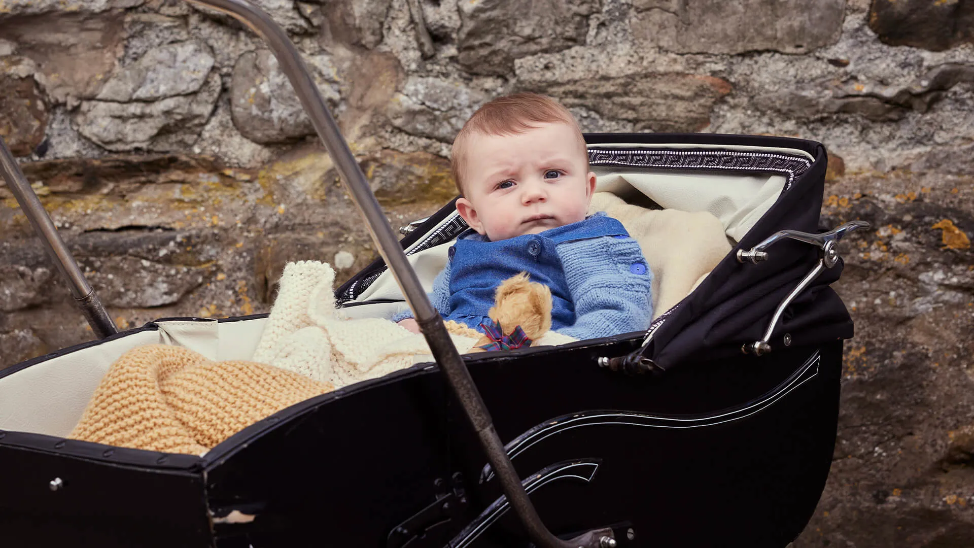 A three-month-old boy dressed in blue in a pram in a scene from All Creatures Great and Small Season 5 on MASTERPIECE on PBS.
