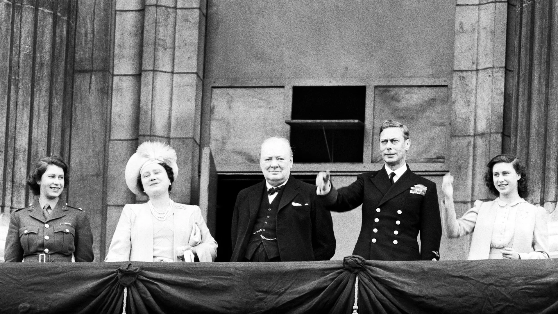 Winston Churchill joins members of the Royal Family on the balcony of Buckingham Palace during VE Day celebrations. Princess Elizabeth is far right joined by her parents and sister Margaret.