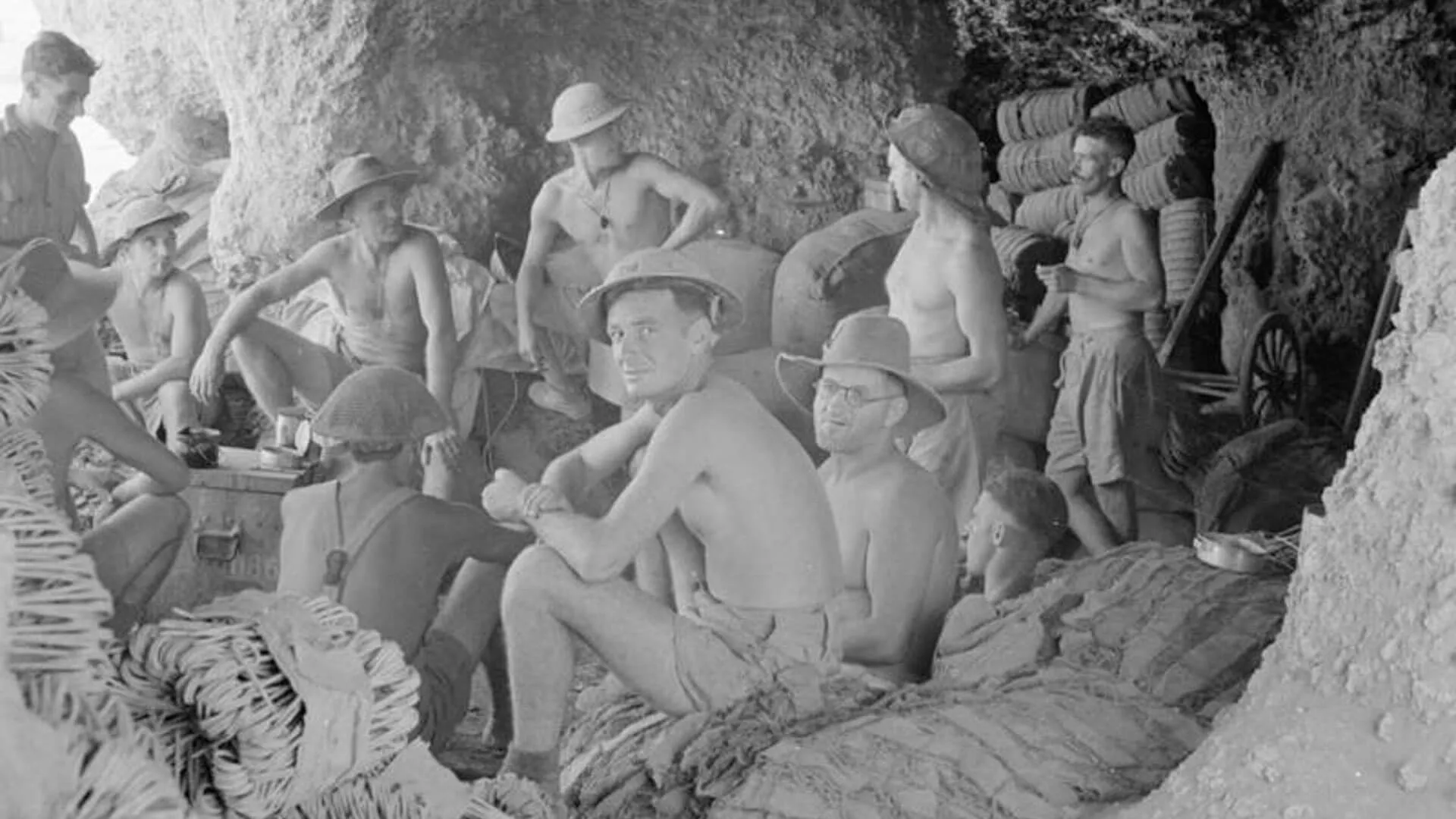 Black and white photo of "The Rats of Tobruk," Australian forces shelter in caves during an air raid in North Africa, WW2.