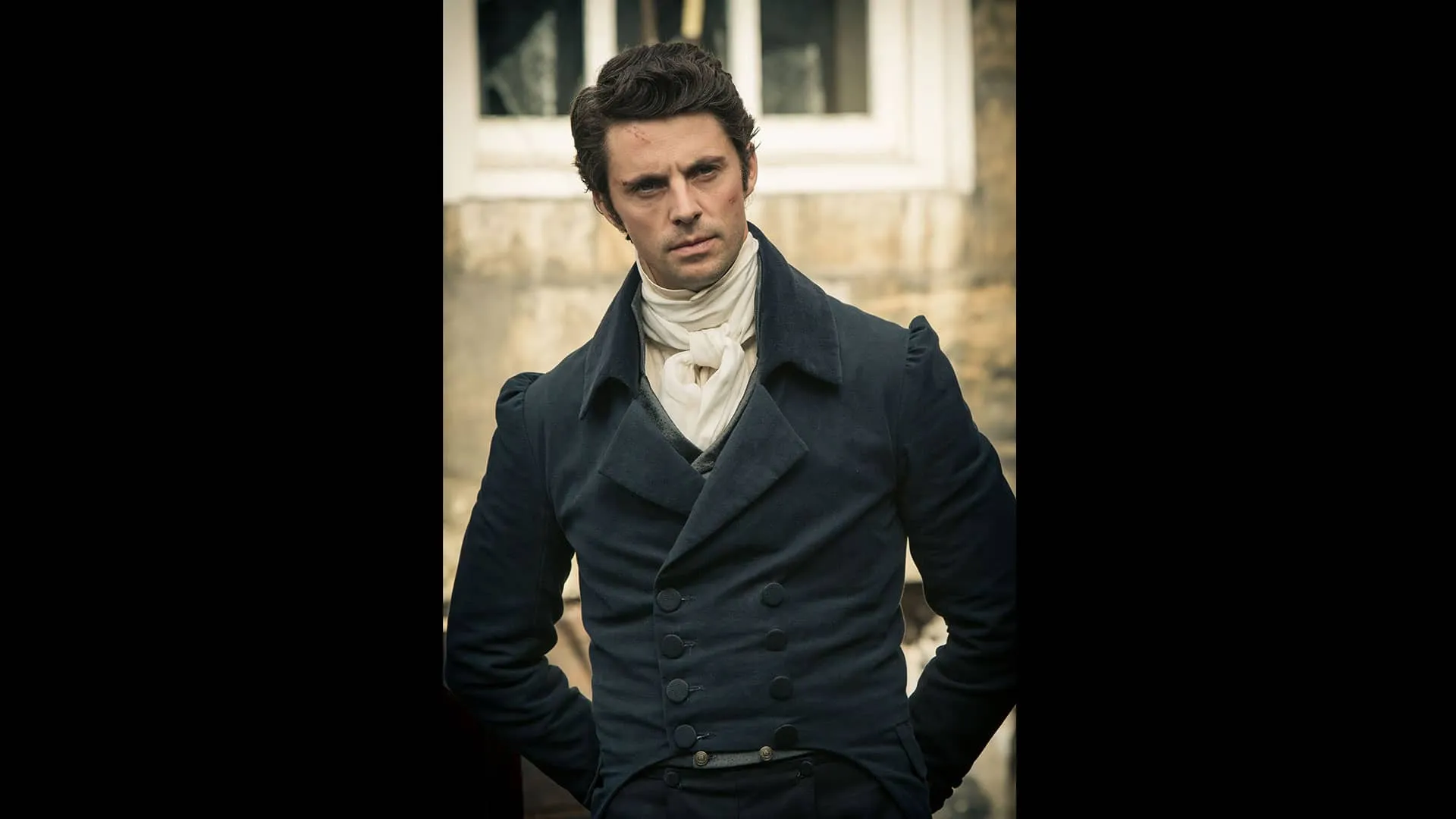 Death Comes to Pemberley's Wickham (Matthew Goode), with scrapes on his face and hands behind his back, looking angry