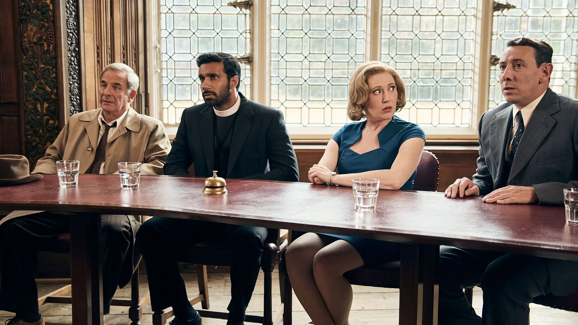 Robson Green as Geordie, Rishi Nair as Alphy, Melissa Johns as Miss Scott, and Al Weaver as Leonard Finch all sitting at a table in Grantchester Season 11