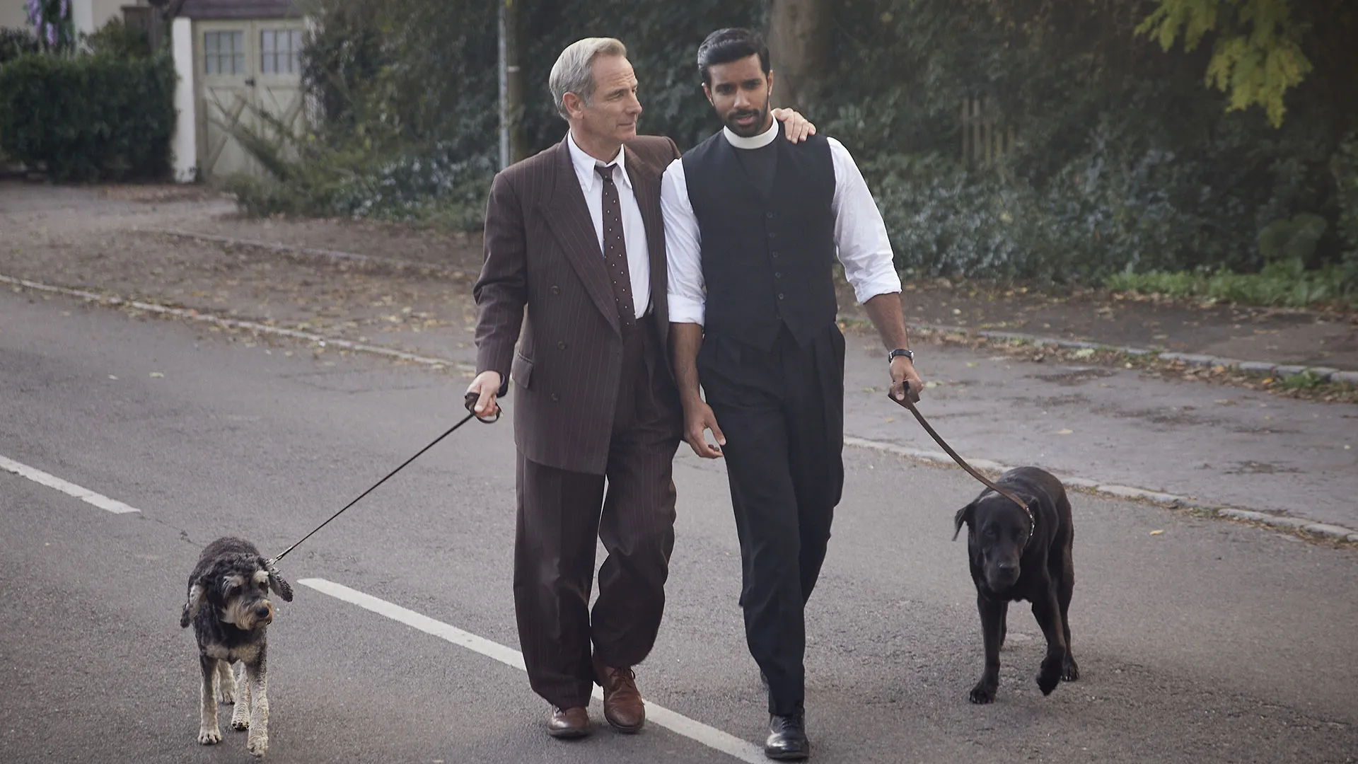 Robson Green and Rishi Nair as Geordie and Alphy walking side by side in Grantchester