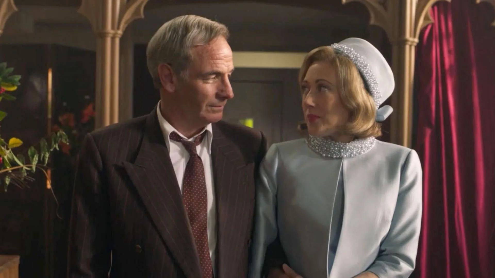 Robson Green as Geordie Keating and Melissa Johns as Miss Scott walking side by side down an aisle in Grantchester Season 10