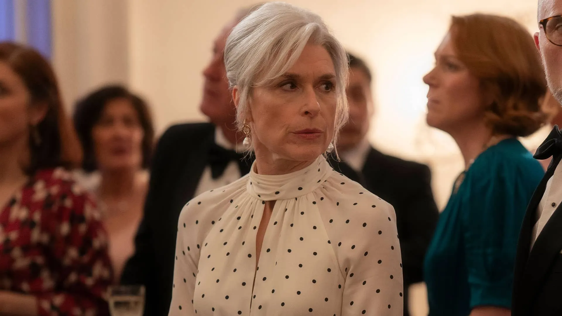 Elaine Clover (Amelia Bullmore), elegant scowling over her shoulder, in Marble Hall Murders