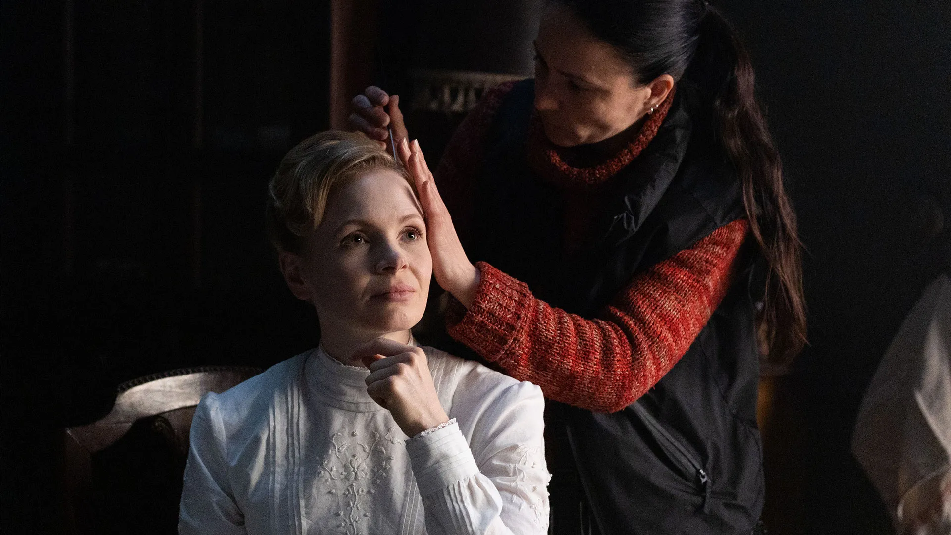 Kate Phillips (Eliza Scarlet) getting her hair touched up behind the scenes of Miss Scarlet Season 6