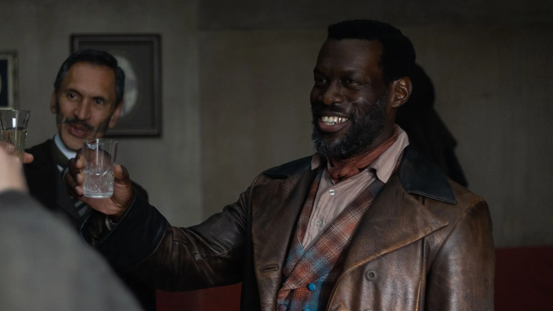 Ansu Kabia as Moses Valentine raising his glass in Miss Scarlet Season 6