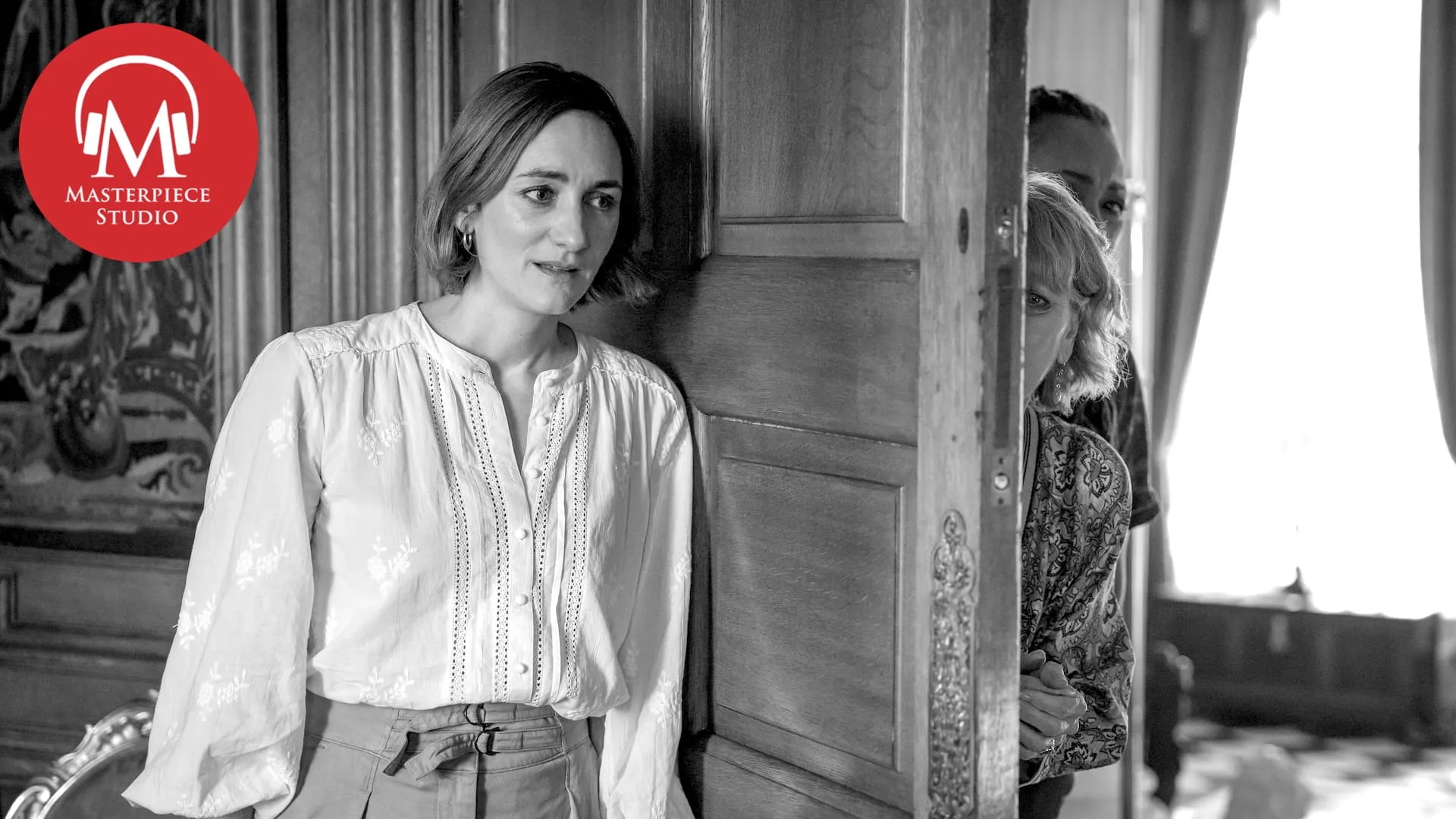 black and white photo of actor cara horgan as becks starling in the marlow murder club with the red masterpiece studio podcast logo in the top left corner