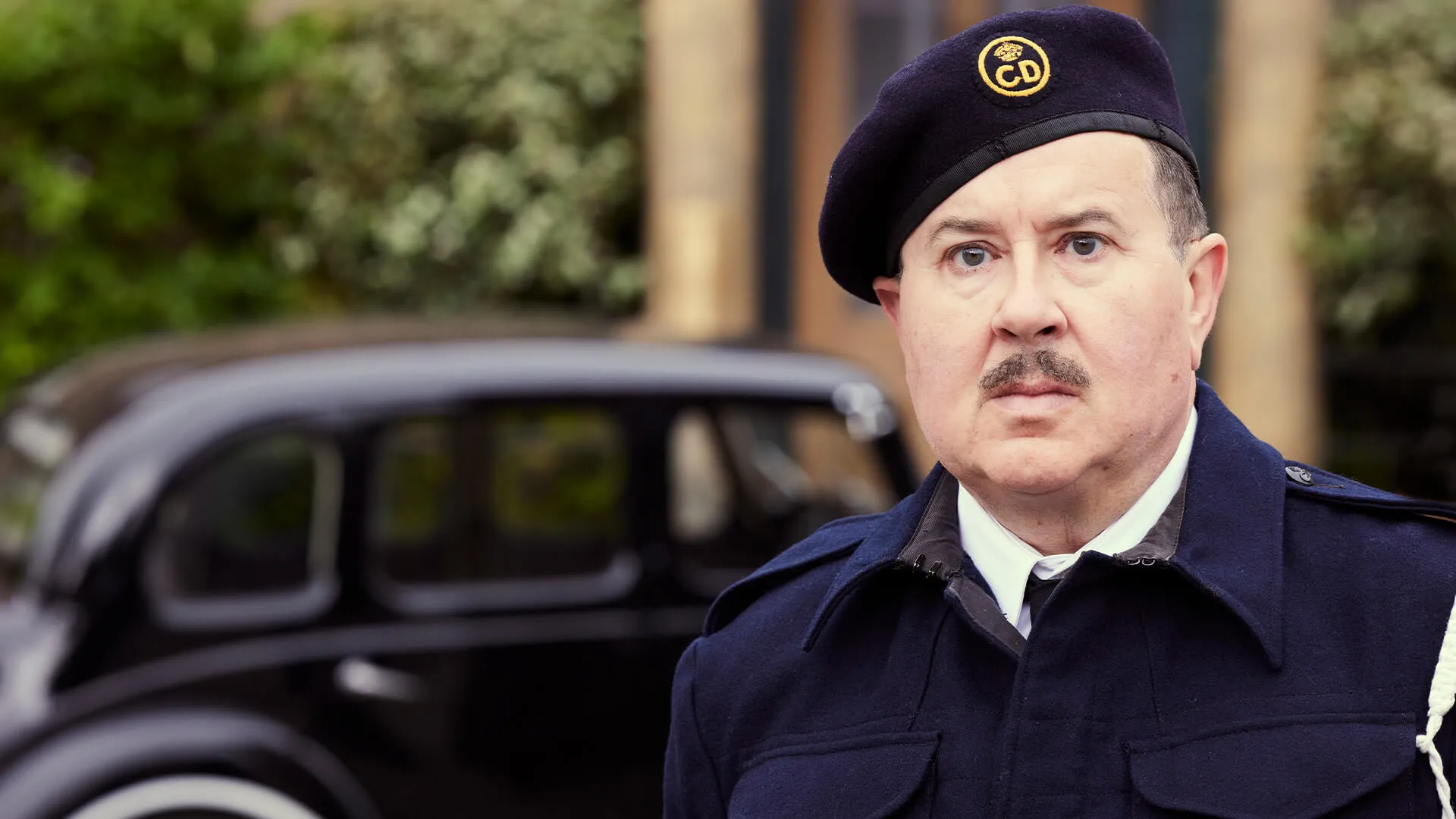 Actor Jeremy Swift dressed as a WW2 Air Raid Precaution Warden in a scene from All Creatures Great and Small Season 5, which airs on MASTERPIECE on PBS.