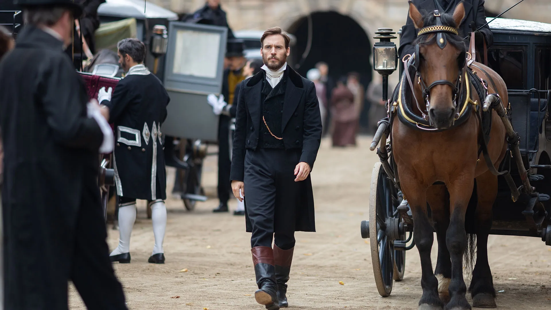 Sam Claflin as Edmond walking down a busy street in The Count of Monte Cristo