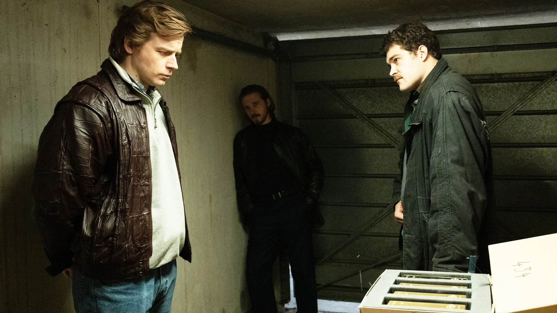 Scene from The Gold Season 1 with fencer character Kenneth Noye examining the Brink's-Mat gold heist.